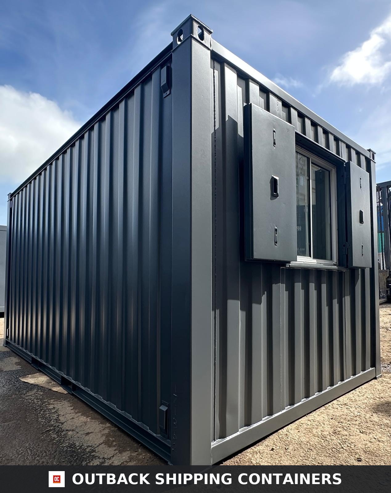 16x9 ft 16x9FT for Sale — Door and Entry Detail | Outback Shipping Containers Side profile of a dark grey 16x9 anti-vandal portable building with open steel window shutters