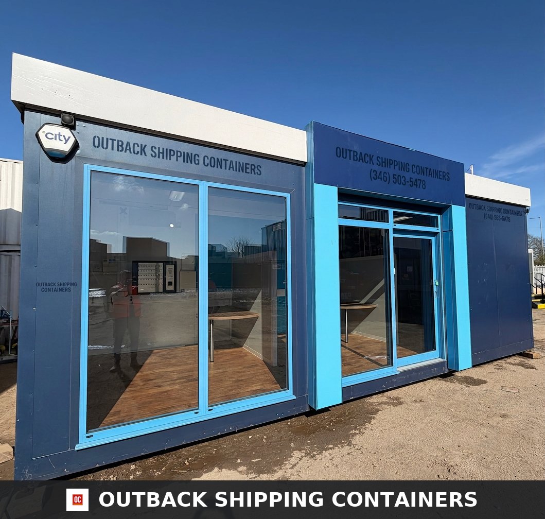 26x12ft for Sale — Side Profile View | Outback Shipping Containers Refurbished 26x12ft portable marketing suite with blue panels and large glass windows under a clear sky