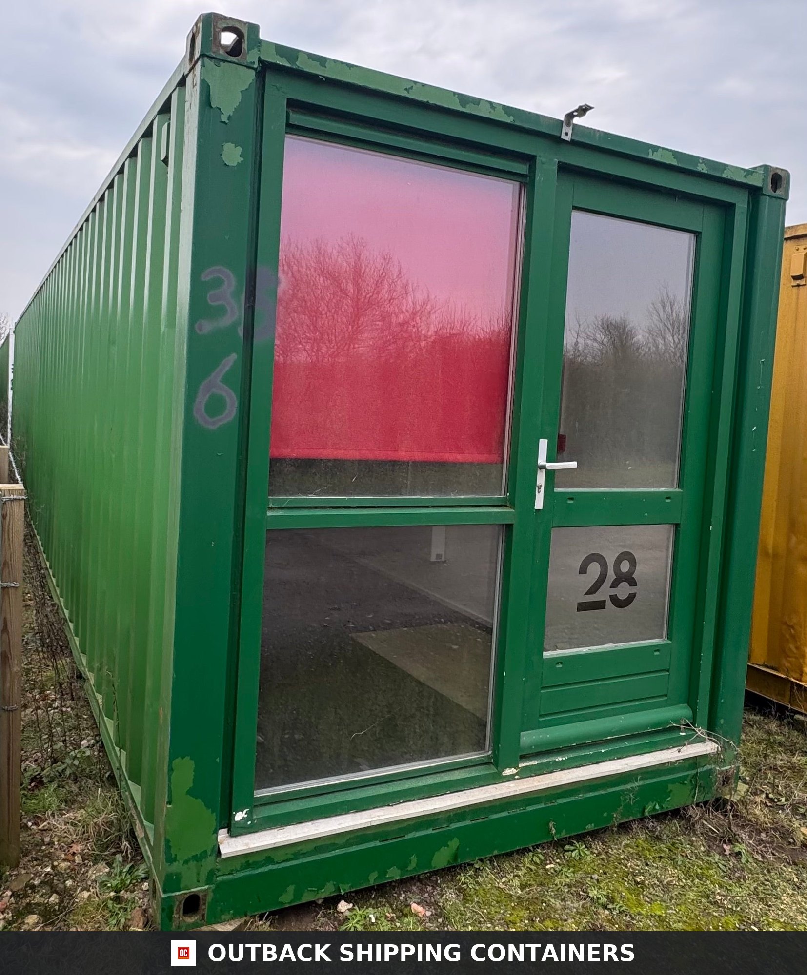 40 Ft Converted Shipping Container Home 40FT — Interior View | Outback Shipping Containers Exterior view of a 40ft green shipping container home with large glass windows and a front door
