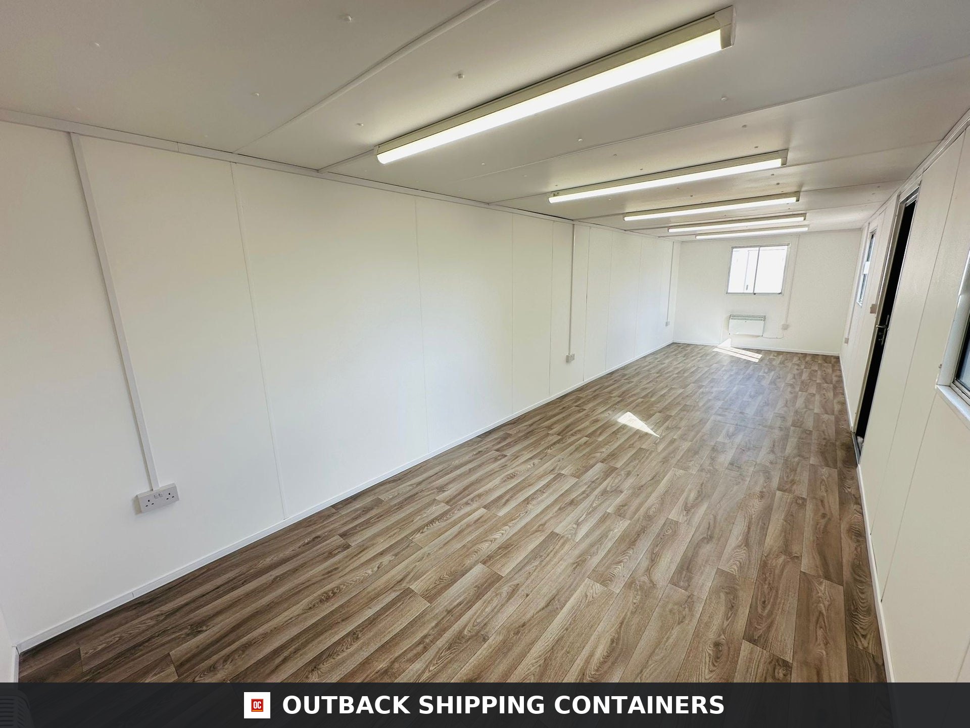 32ft Cabin for Sale — Roof and Structural Detail | Outback Shipping Containers 2 3 Interior of a refurbished 32ft anti-vandal portable cabin showing wood-effect vinyl flooring and white walls