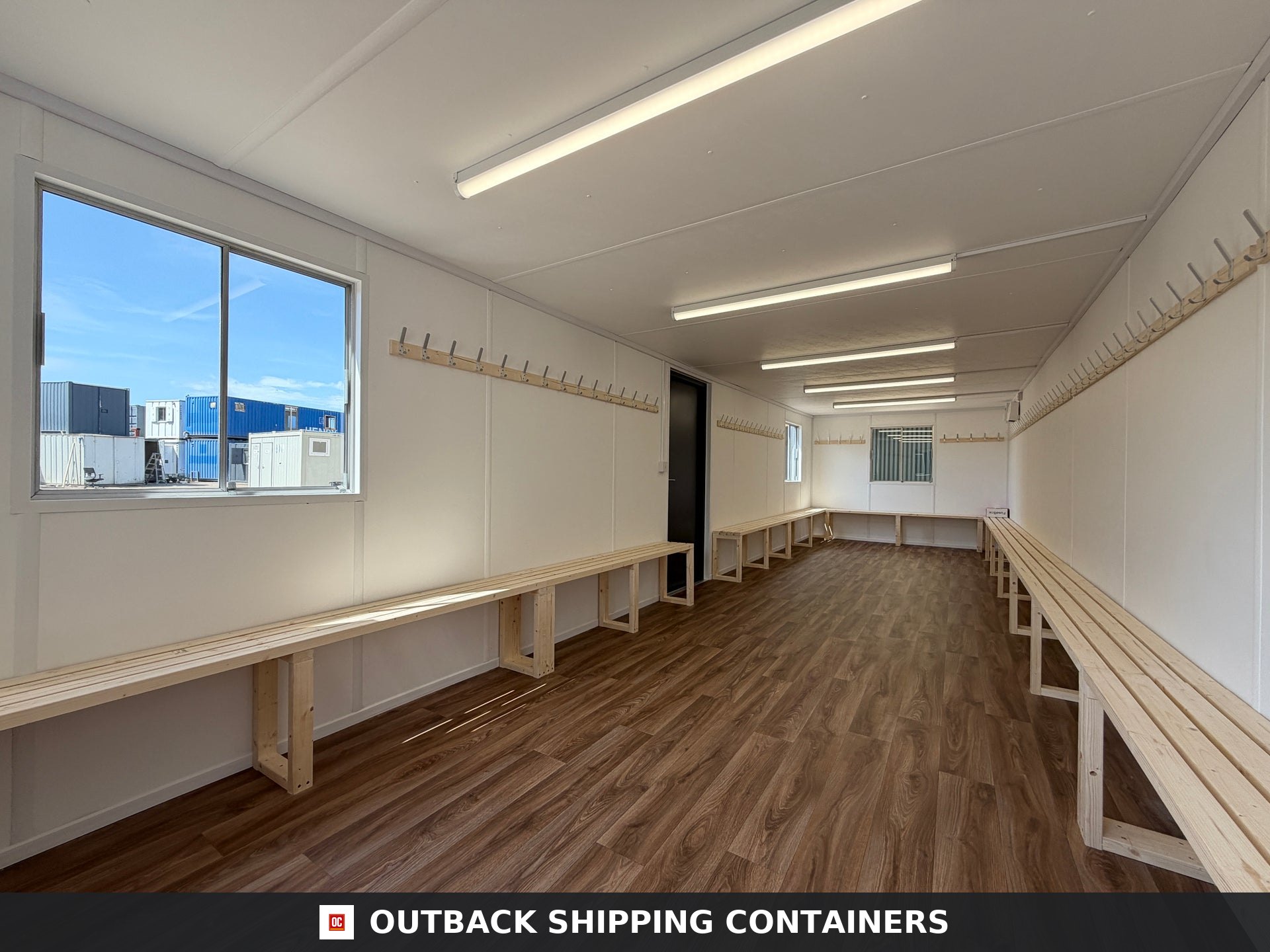 32x10ft Cabin for Sale — Interior Detail | Outback Shipping Containers 2 3 4 Interior view of a 32x10 drying room container with wooden benches, wall hooks, and overhead LED lighting