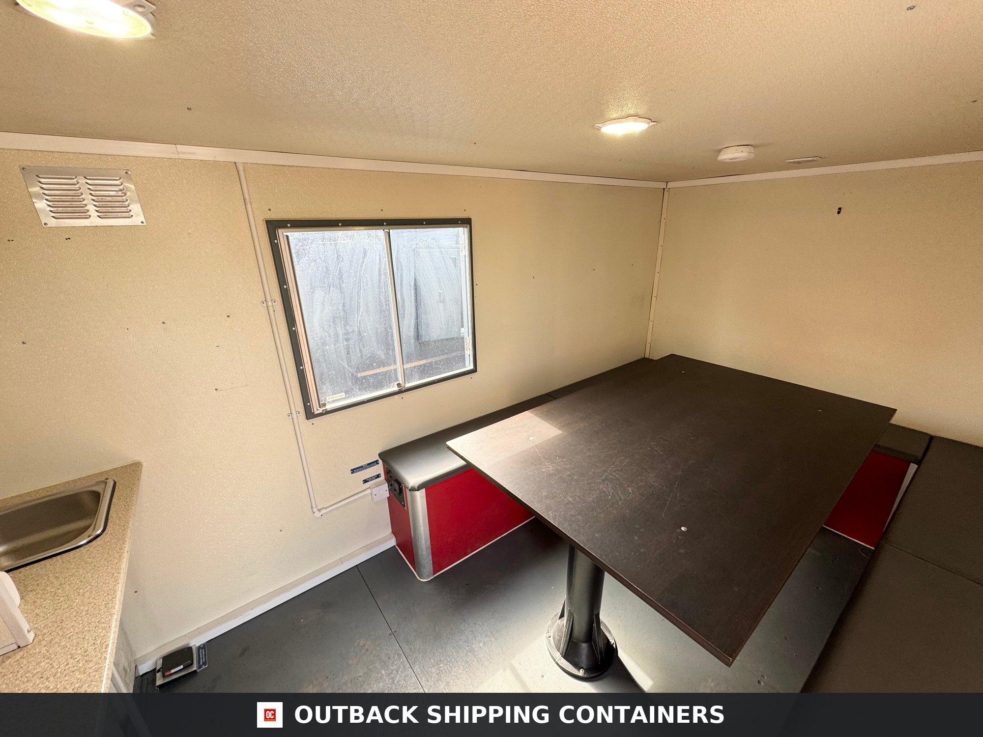Groundhog Towable Mobile Welfare | 2019 Twin Axle 16ft Welfare | GPO500 — Rear Exterior View Interior view of Groundhog towable mobile welfare unit featuring a large canteen table with bench seating and window