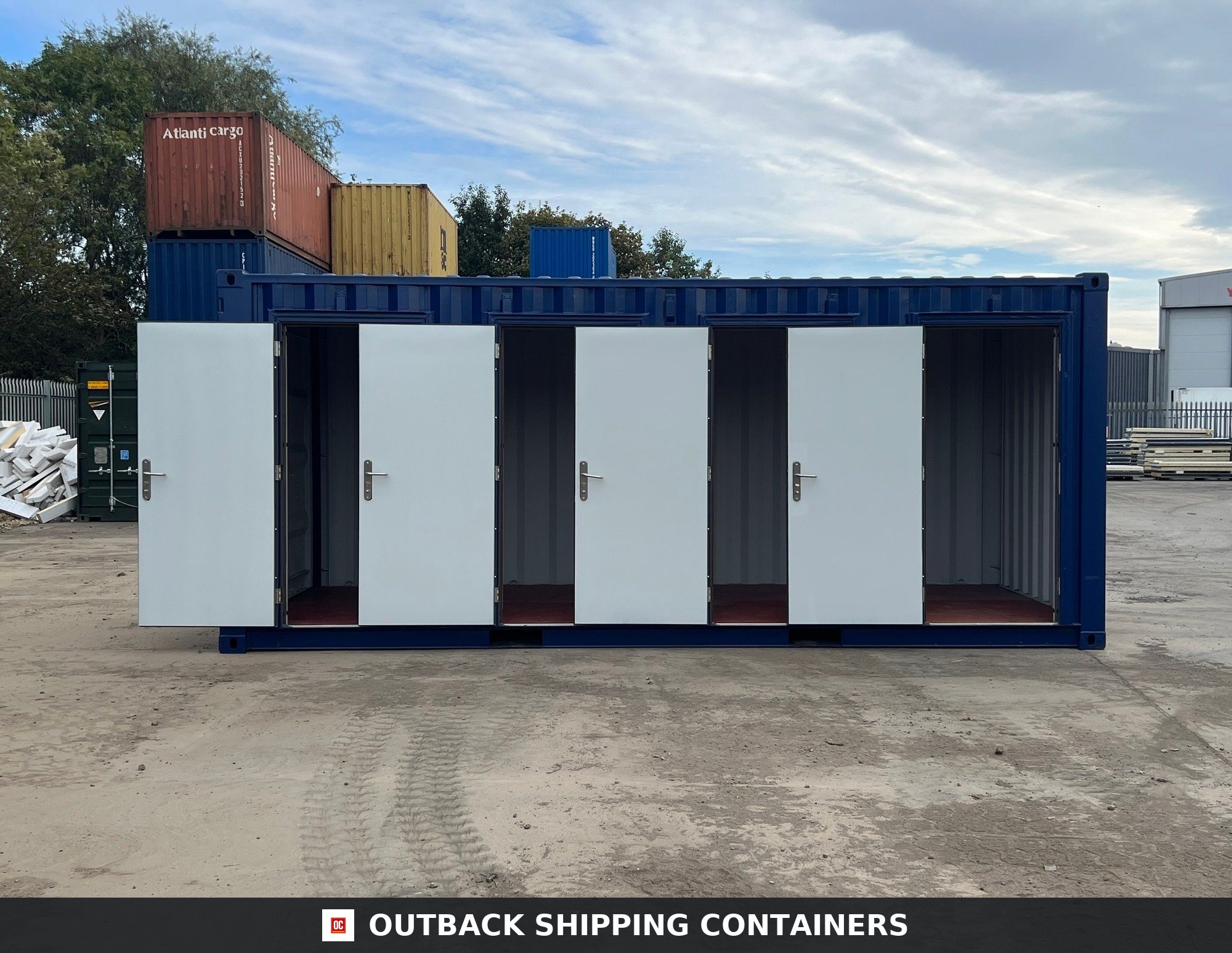 20ft shipping container modified with four side-opening white human access doors for multi-unit self storage