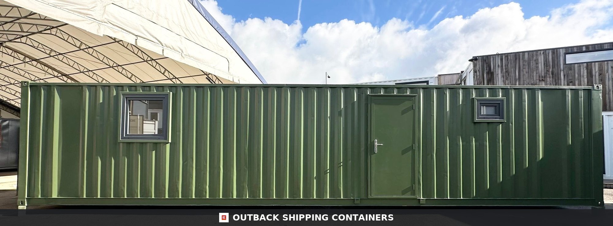 40ft green shipping container office with a steel personnel door and two glass windows under a clear sky