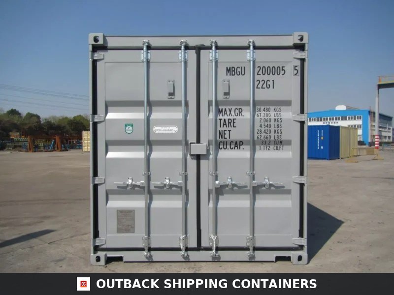 Rear view of a new 20ft grey shipping container showing locked cargo doors and identification markings