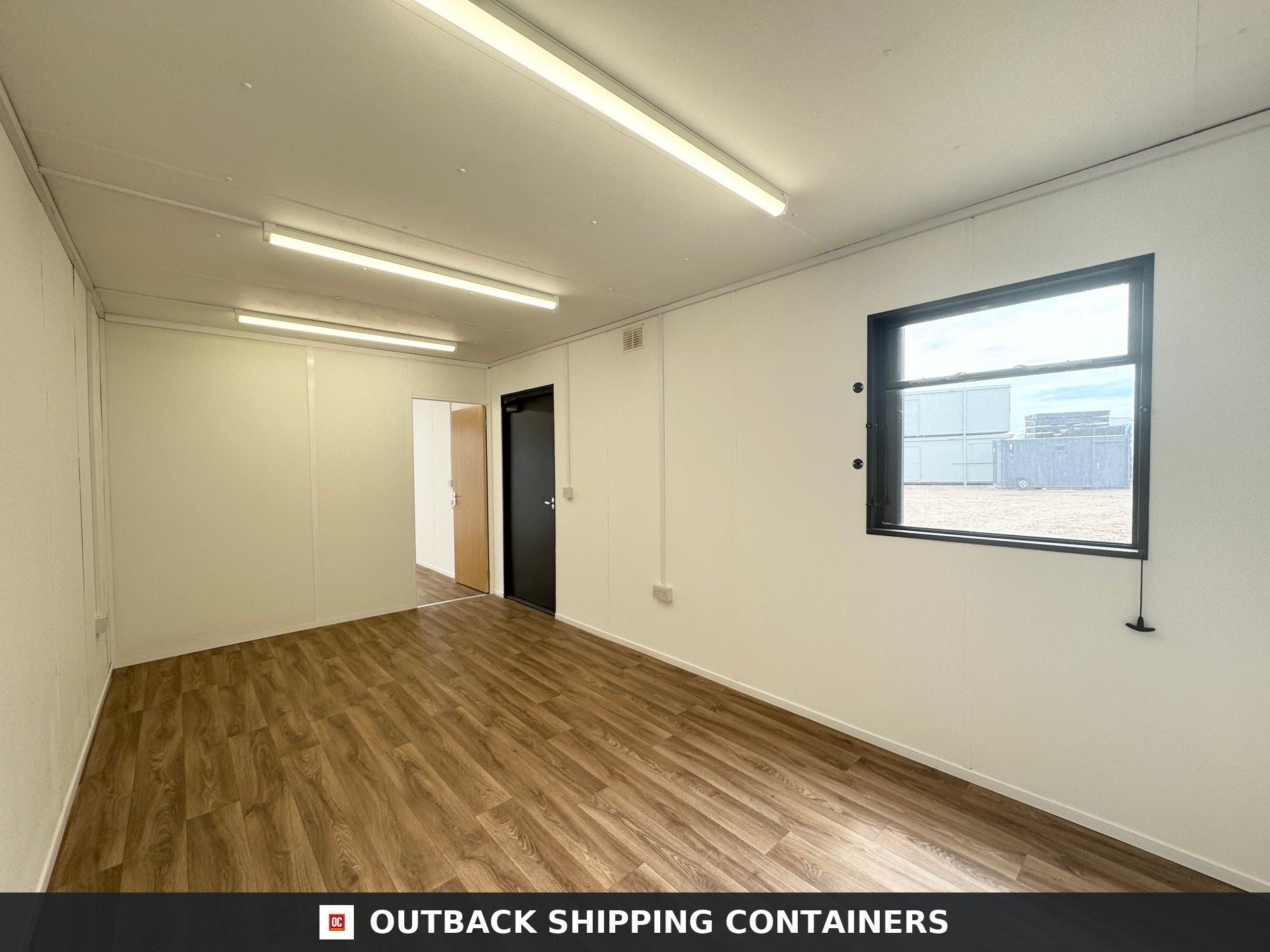 32x10 ft 32x10FT for Sale — Roof and Structural Detail | Outback Shipping Containers Interior view of refurbished 32x10 portable office with wood-style flooring and white walls