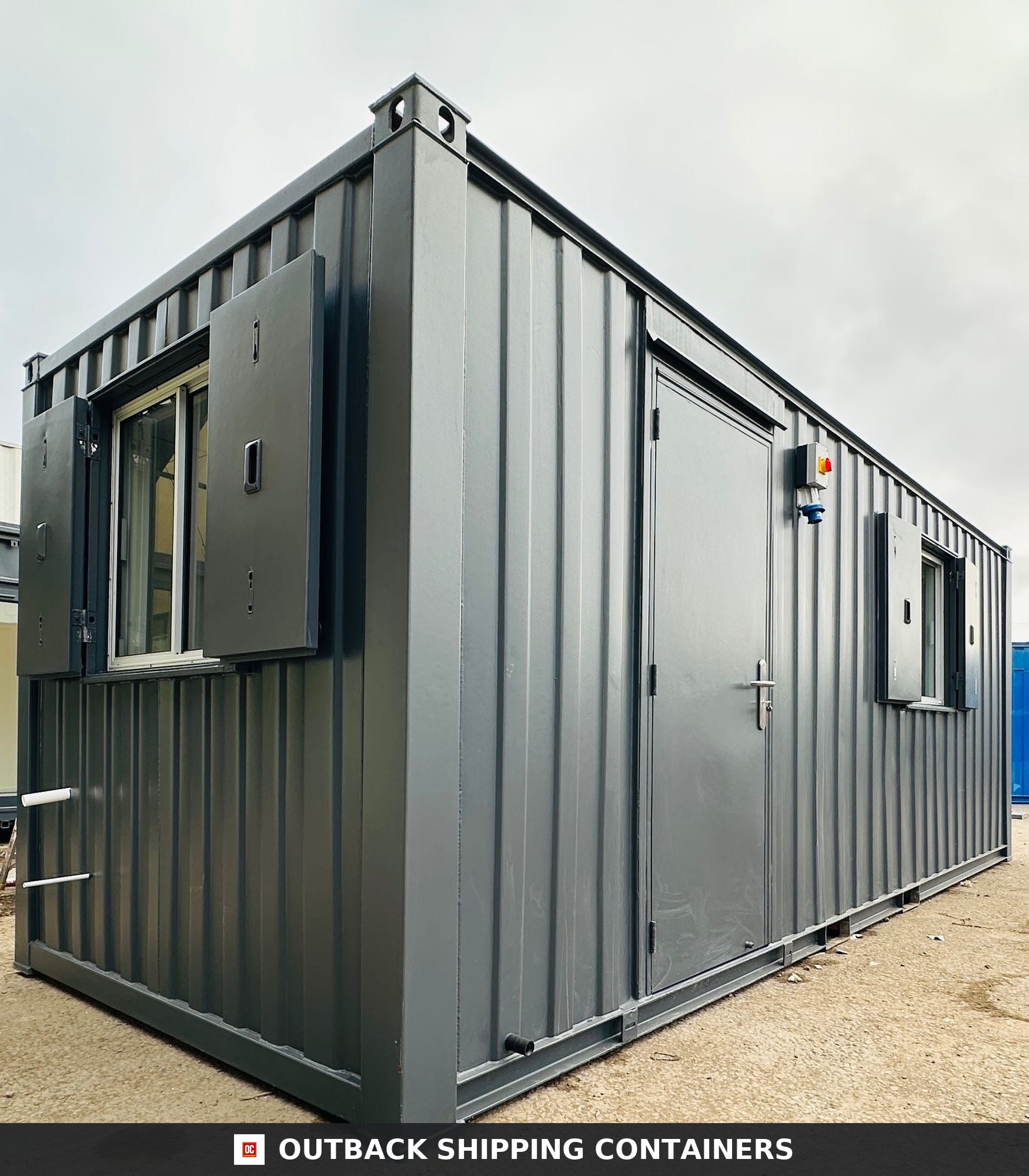 21x8ft for Sale — Three-Quarter Angle View | Outback Shipping Containers 21ft anti-vandal shipping container office with gray steel exterior, secure shutters, and a locked personnel door