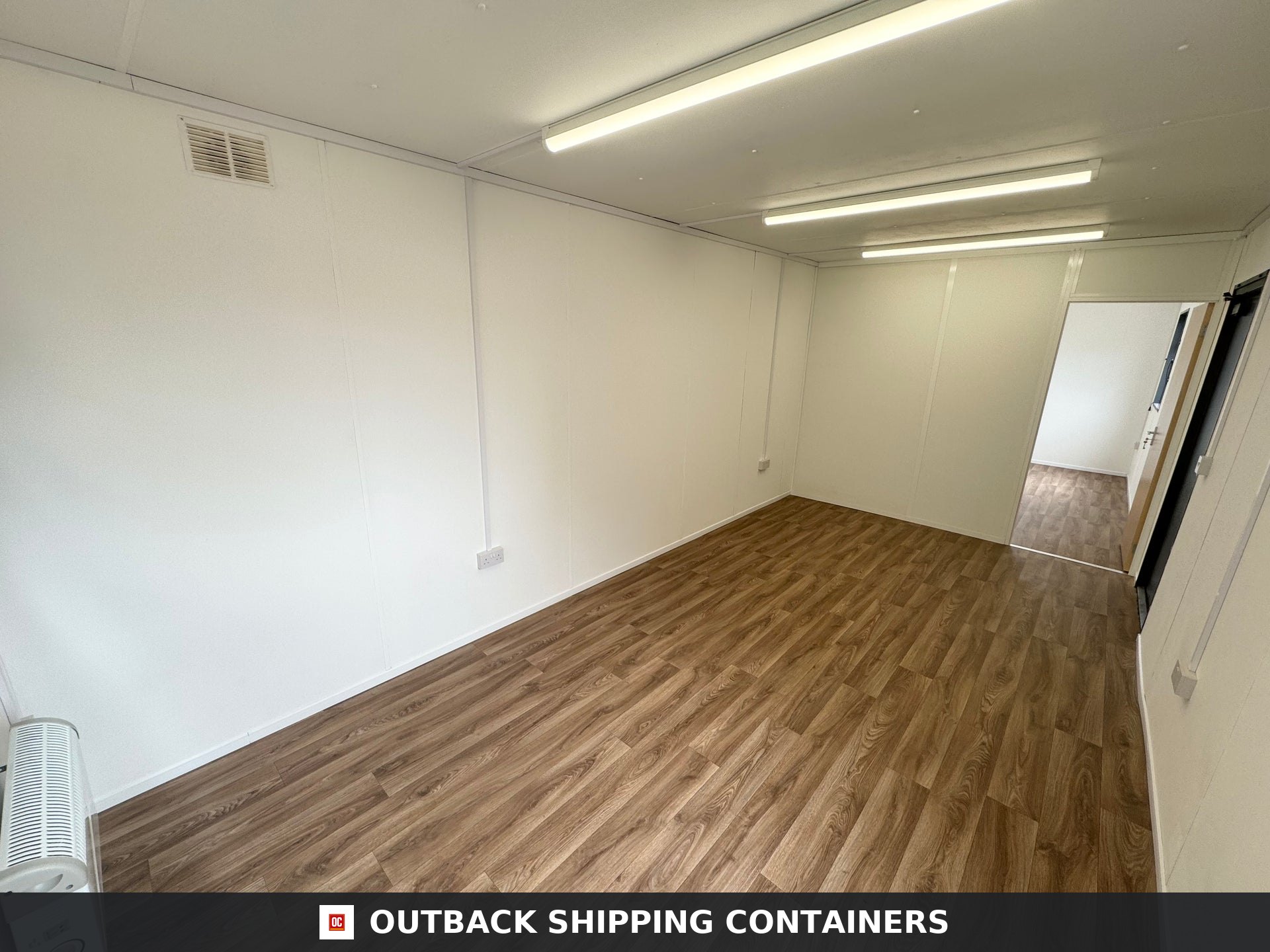 32x10 ft 32x10FT for Sale — Window and Shutter Detail | Outback Shipping Containers Interior of a refurbished 32x10 portable office cabin with wood-look flooring and white paneled walls