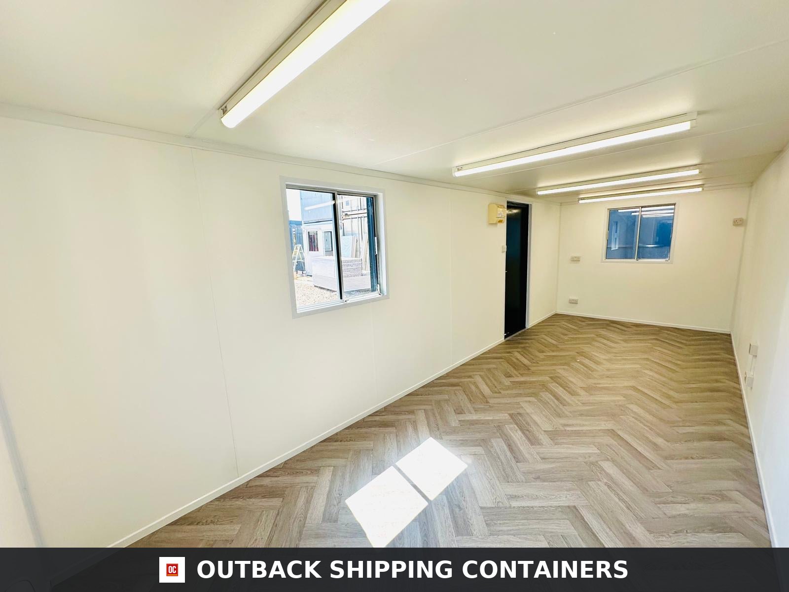 24x9 ft 24x9FT for Sale — Window and Shutter Detail | Outback Shipping Containers 24x9 ft open plan office interior with herringbone floors and white walls