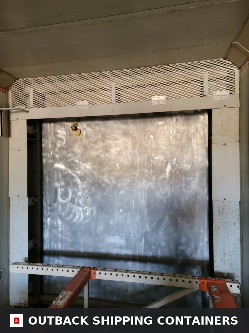 Interior view of a Stoughton storage container featuring a metal partition wall and mesh ventilation screen