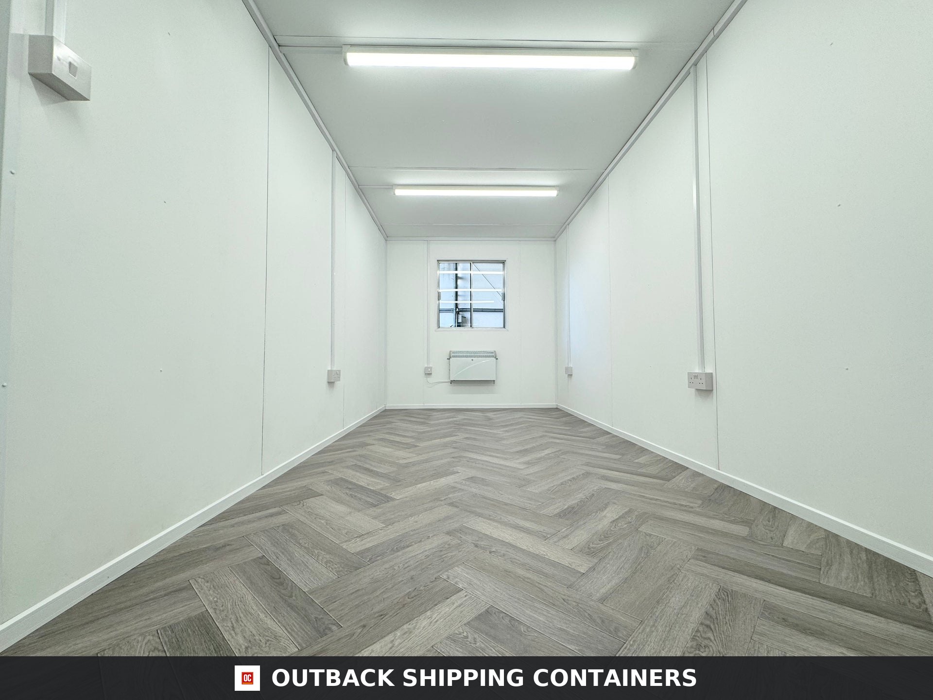 20x8ft for Sale — Three-Quarter Angle View | Outback Shipping Containers Interior view of refurbished 20ft mobile office container with white walls and herringbone wood floors