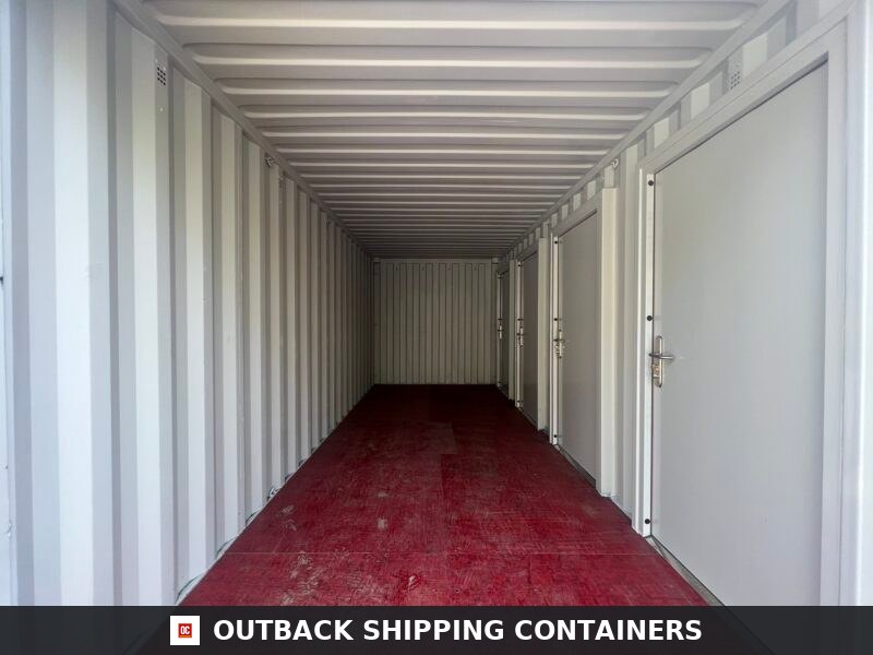 Interior view of a 20ft multi-unit storage container with white walls, red flooring, and built-in side doors