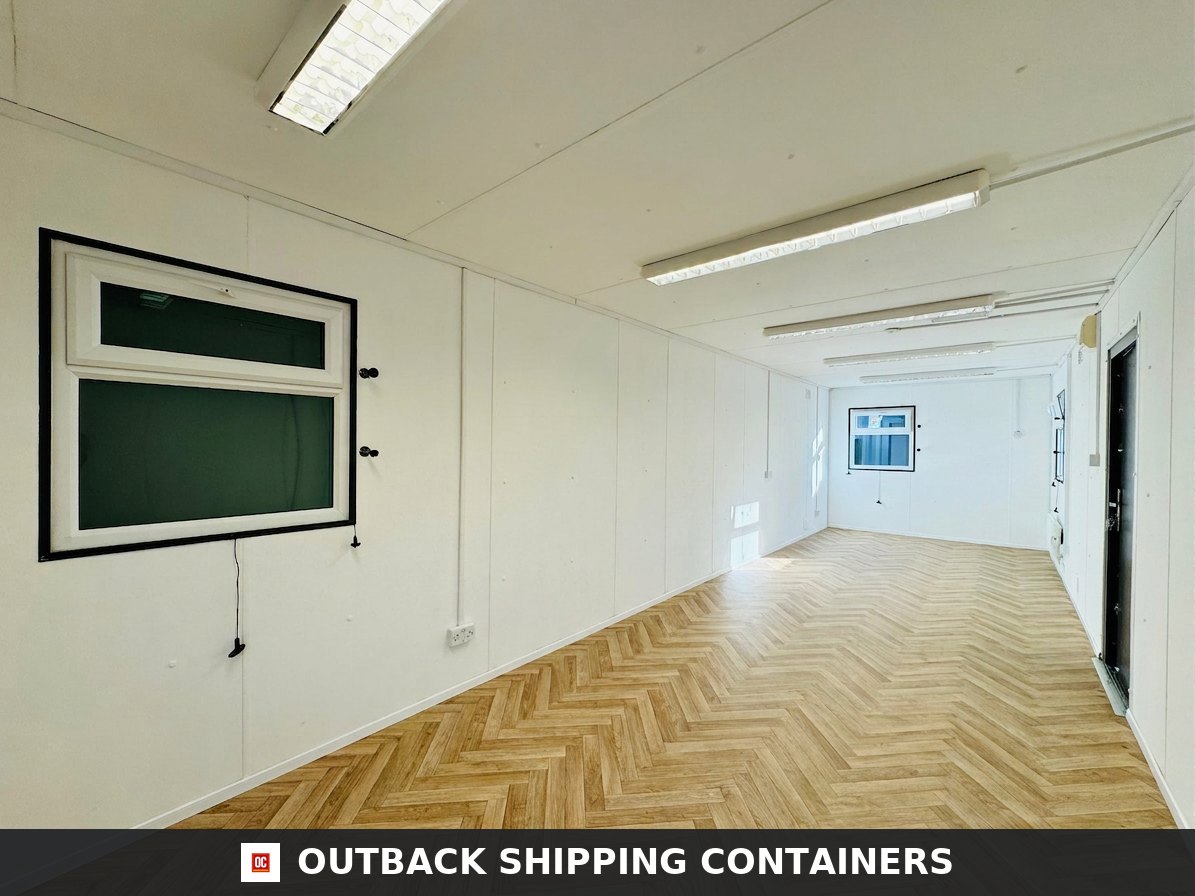 32ft Cabin for Sale — Side Profile View | Outback Shipping Containers 2 Refurbished 32ft shipping container office interior with white walls, herringbone wood floors, and fluorescent lights