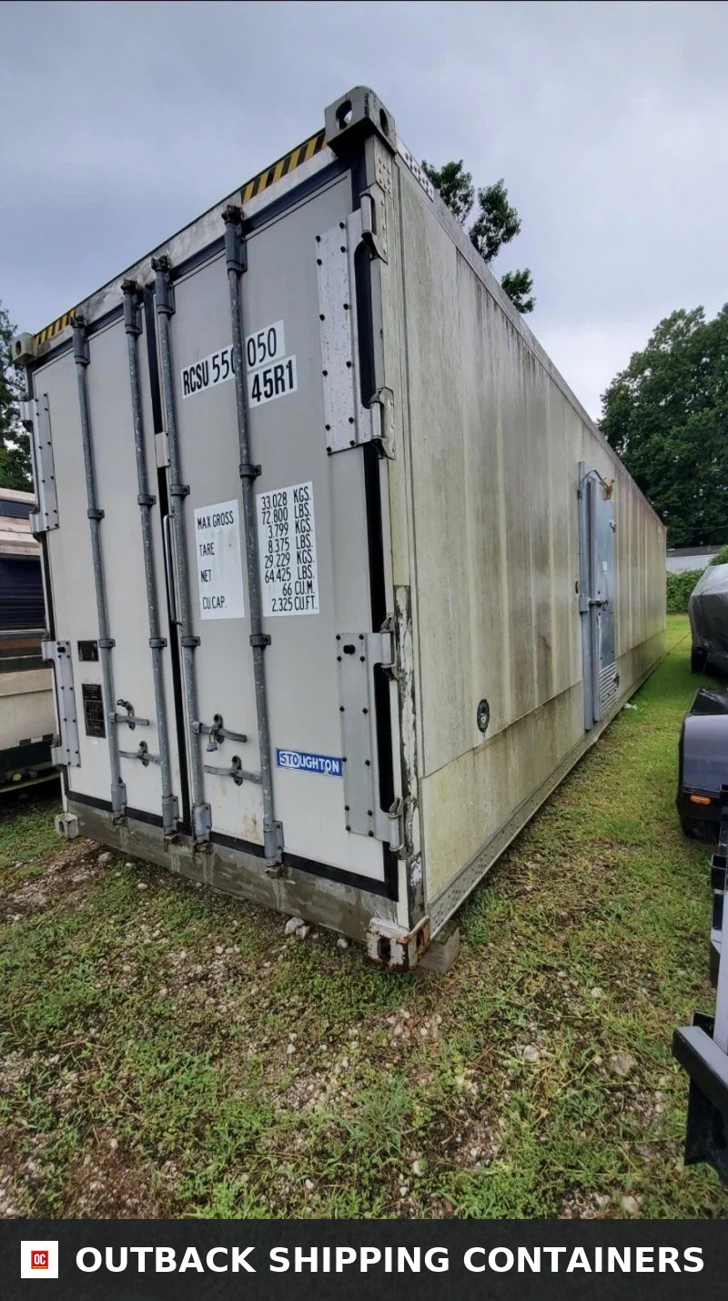 Rear and side view of a white 40ft Stoughton shipping container with gray door locking bars on grass