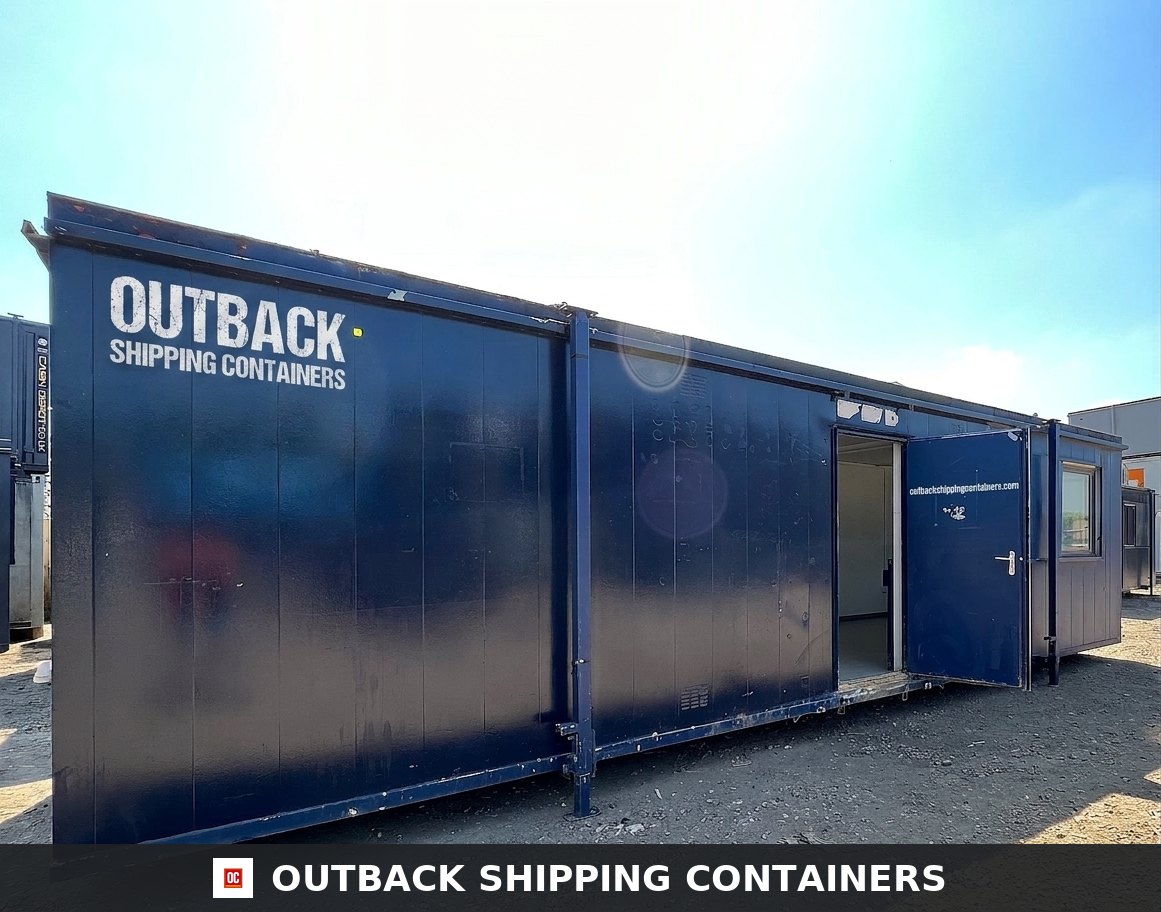 24x9 ft 24X9FT for Sale — Interior Detail | Outback Shipping Containers Blue 24x9 anti-vandal portable office cabin with an open steel door on a gravel lot under bright sunlight