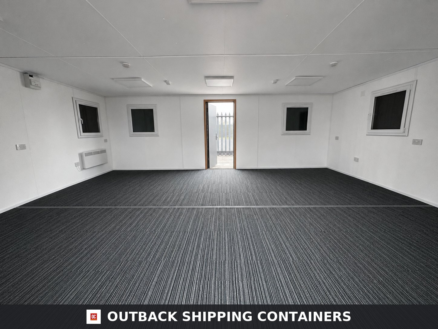 Modular Building 2 Bay 24x20FT for Sale — Side Profile View | Outback Shipping Containers Interior view of a 24x20ft refurbished 2 bay modular building with grey carpet and white walls