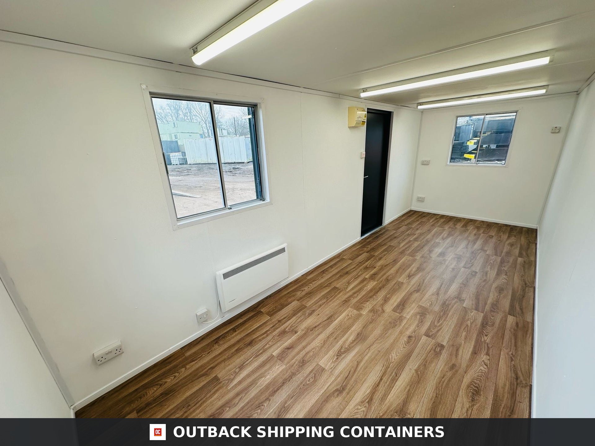 21x8ft for Sale — Three-Quarter Angle View | Outback Shipping Containers 2 3 4 5 Interior view of a refurbished 21x8ft portable office container with wood-look flooring and white walls