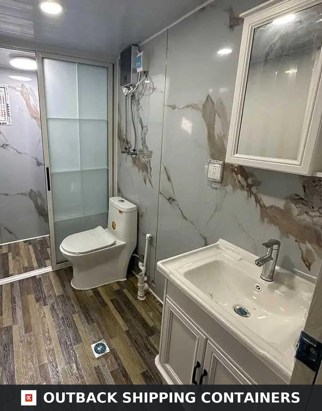 40ft Luxury 3 Bedroom Foldable Container Home for Sale — Marble-Look Full Bathroom | Outback Shipping Containers Full bathroom of the 40ft foldable container home with marble-look wall panels, sliding glass shower screen, vanity and mirror cabinet