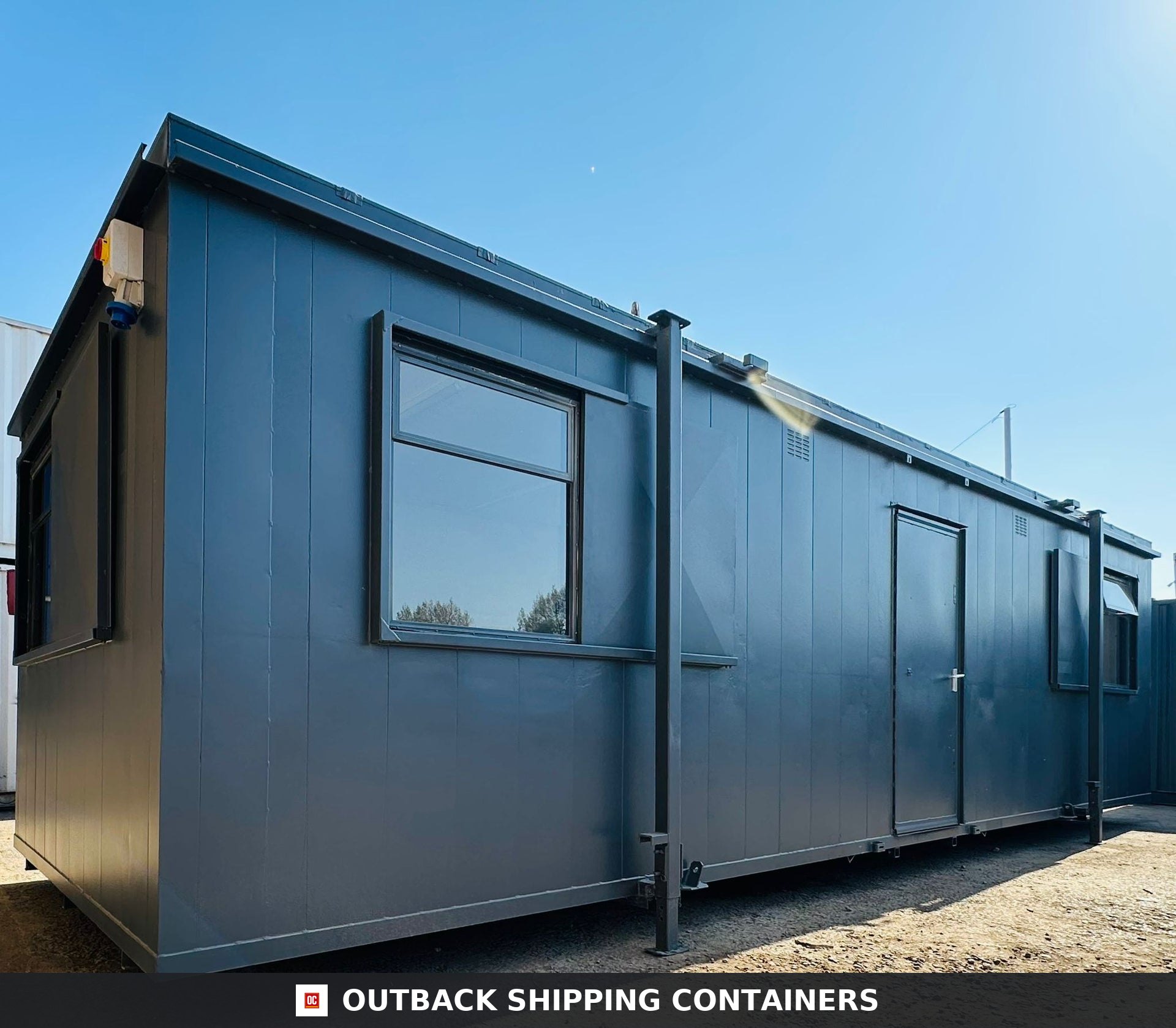 32x10ft Cabin for Sale — Interior Detail | Outback Shipping Containers 2 3 Side profile of a dark grey 32x10ft anti-vandal portable cabin showing window and steel door exterior
