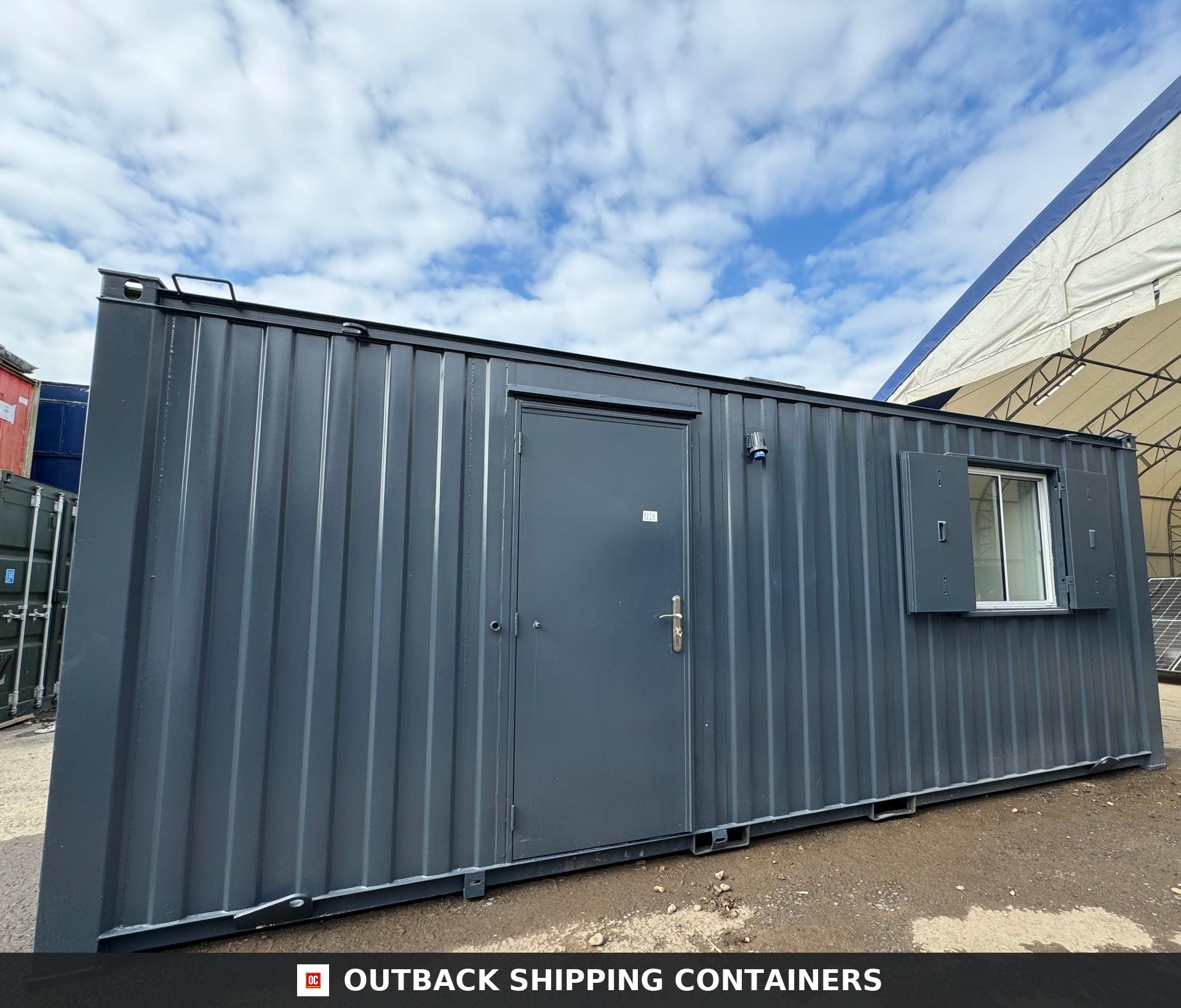 21x8ft for Sale — Rear Exterior View | Outback Shipping Containers 2 Side profile of a dark grey 21ft anti-vandal portable office container with a steel door and shuttered window