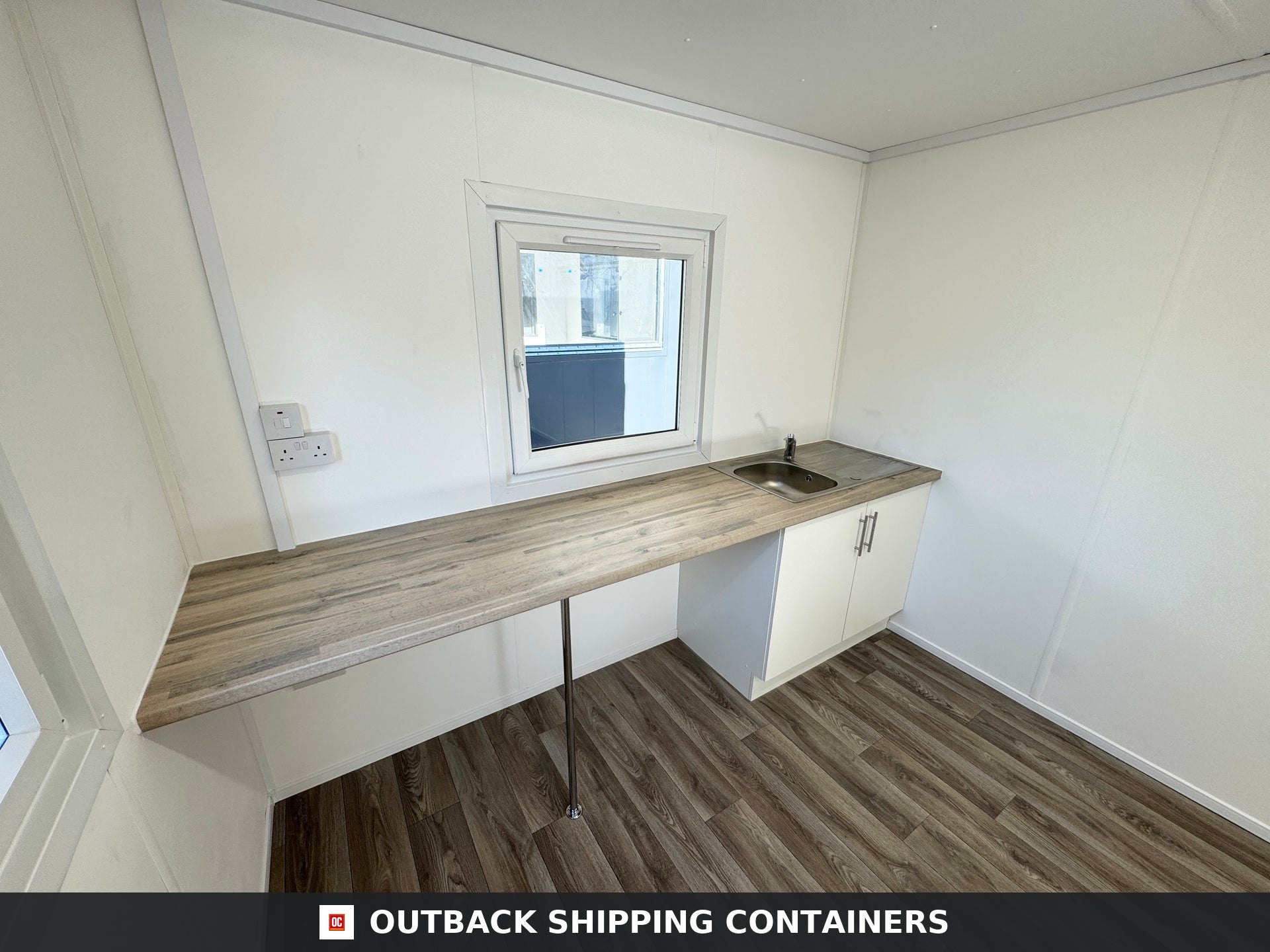 32x10ft Cabin for Sale — Rear Exterior View | Outback Shipping Containers Refurbished 32x10 portable shipping container cabin in dark grey with anti-vandal steel door and shuttered window