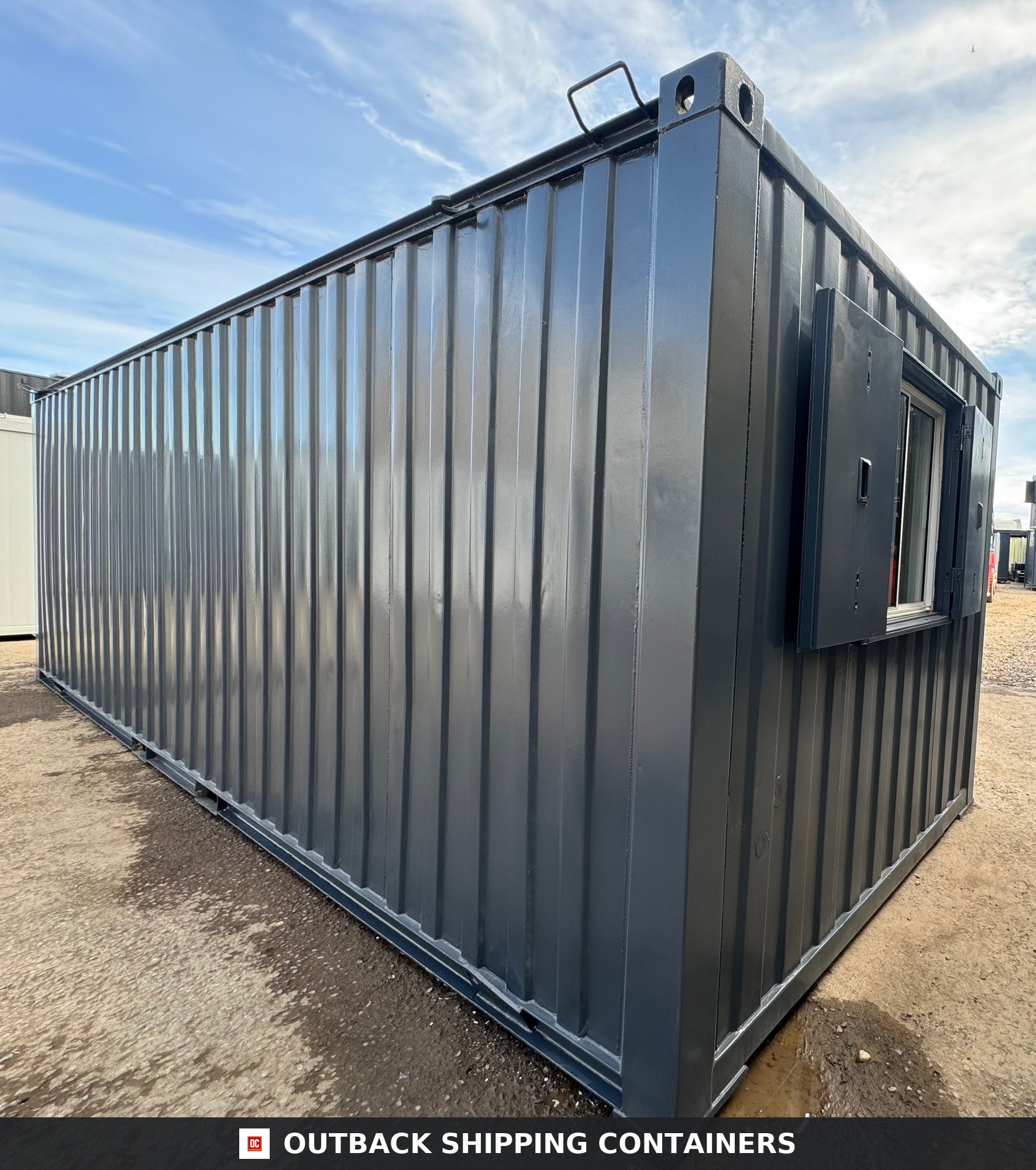 24x9 ft 24x9FT for Sale — Window and Shutter Detail | Outback Shipping Containers Refurbished 24x9 ft anti-vandal office cabin in dark gray steel with open window shutters on a gravel lot