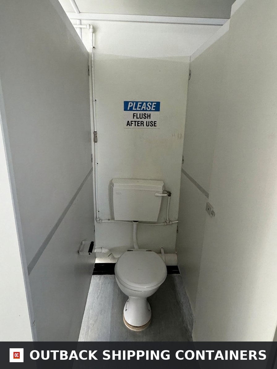 21x8ft for Sale — Side Profile View | Outback Shipping Containers Interior view of a toilet stall inside a 21ft portable cabin with white walls and a please flush after use sign