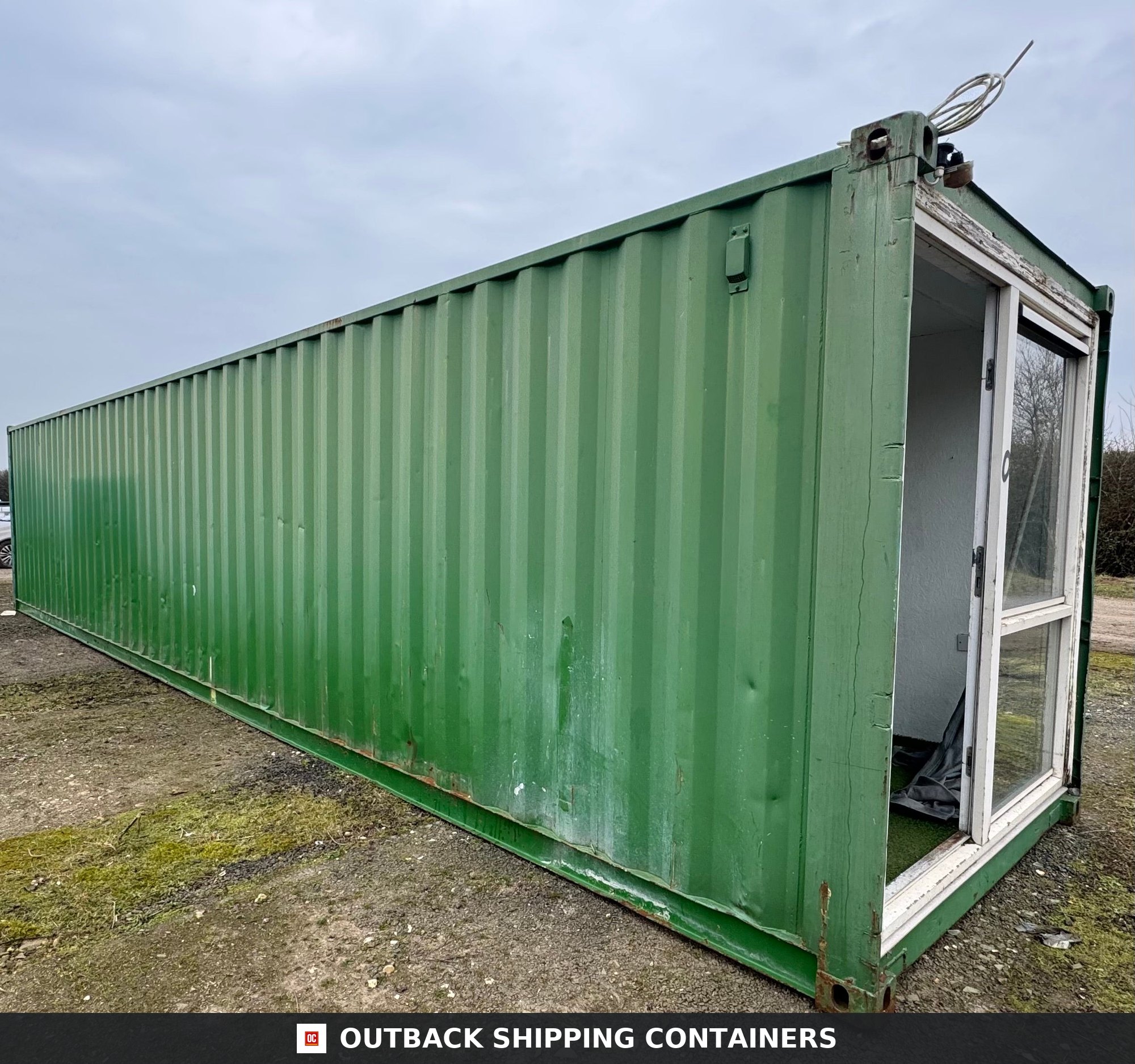 40 Ft Converted Shipping Container 40FT for Sale — Corner Casting and Frame Detail 40ft green converted shipping container office with a white sliding glass door installed on the short end wall