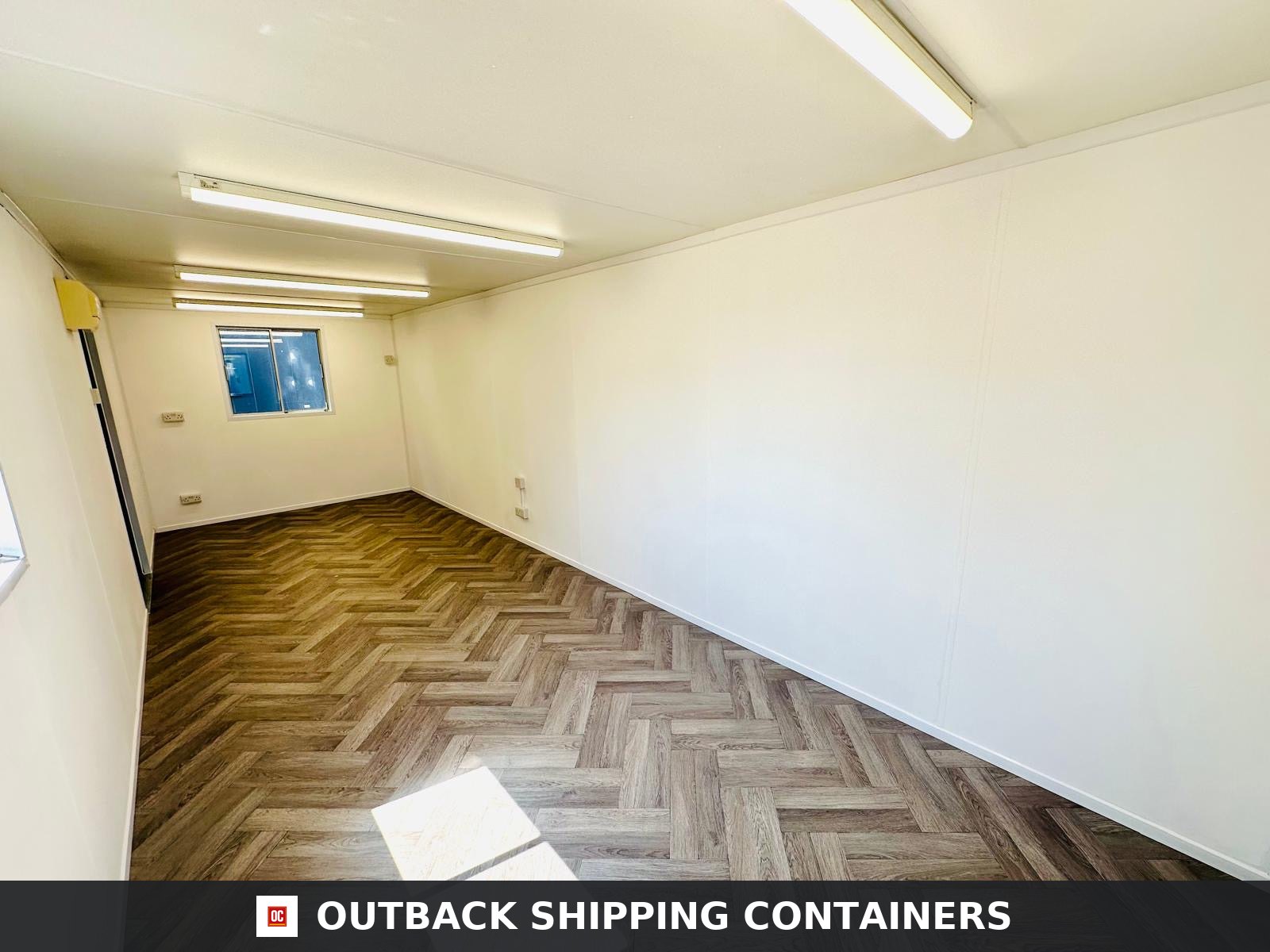24x9 ft 24x9FT for Sale — Door and Entry Detail | Outback Shipping Containers Side profile of a navy blue 24x9ft open plan portable office container with open anti-vandal window shutters