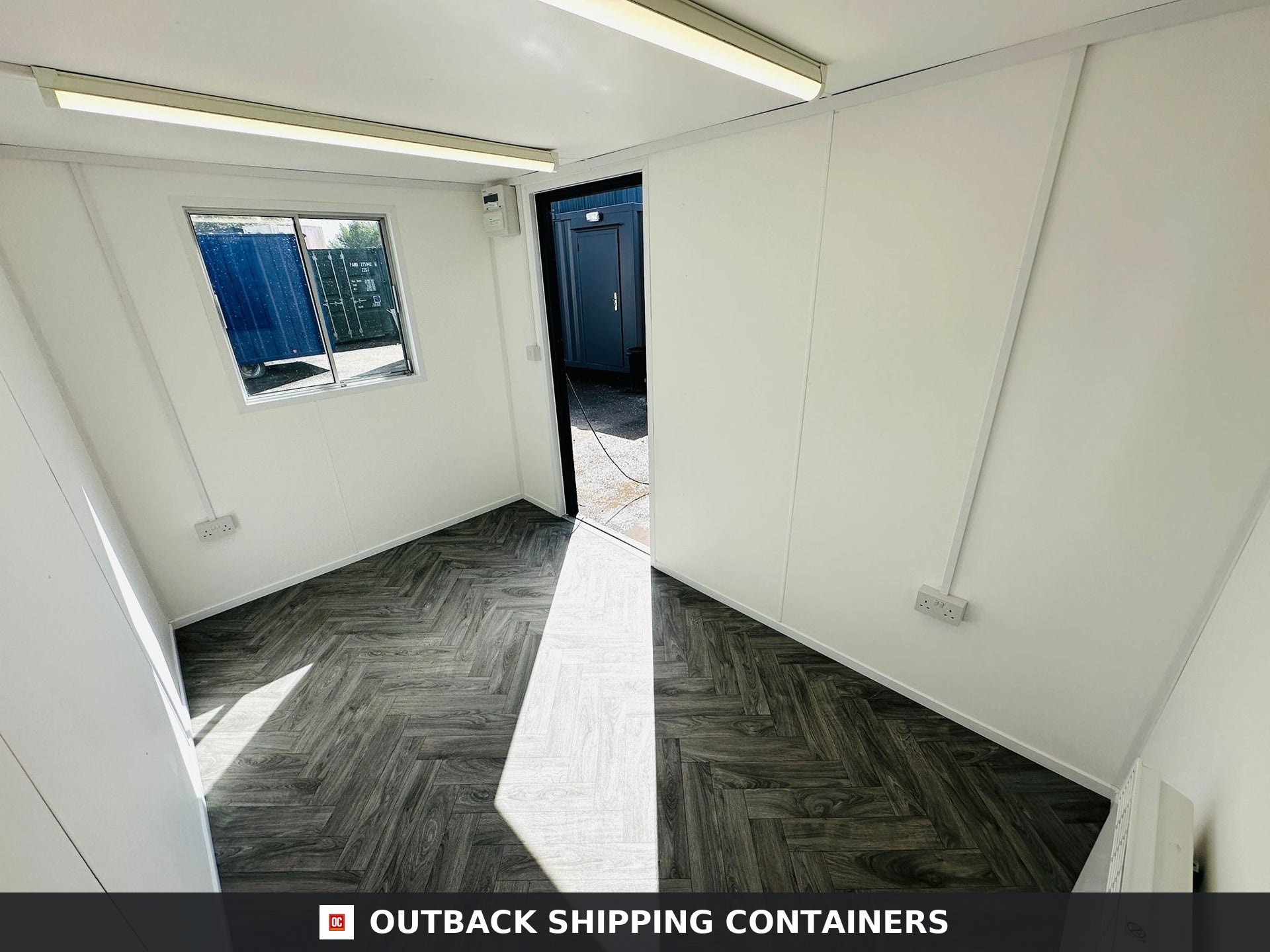 12x8 ft 12x8FT for Sale — Door and Entry Detail | Outback Shipping Containers Side profile of a gray 12x8 portable canteen building with open anti-vandal steel shutters over a window