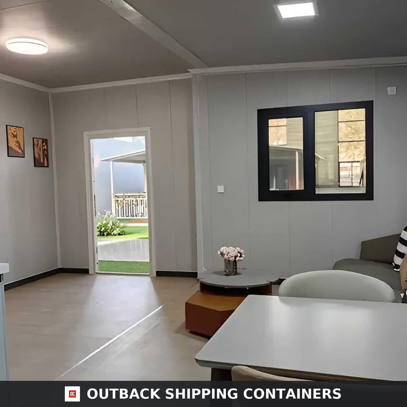 40ft Luxury 3 Bedroom Foldable Container Home for Sale — Open-Plan Living and Dining | Outback Shipping Containers Open-plan living and dining area inside the 40ft 3 bedroom foldable container home with light grey walls and a glazed entry door