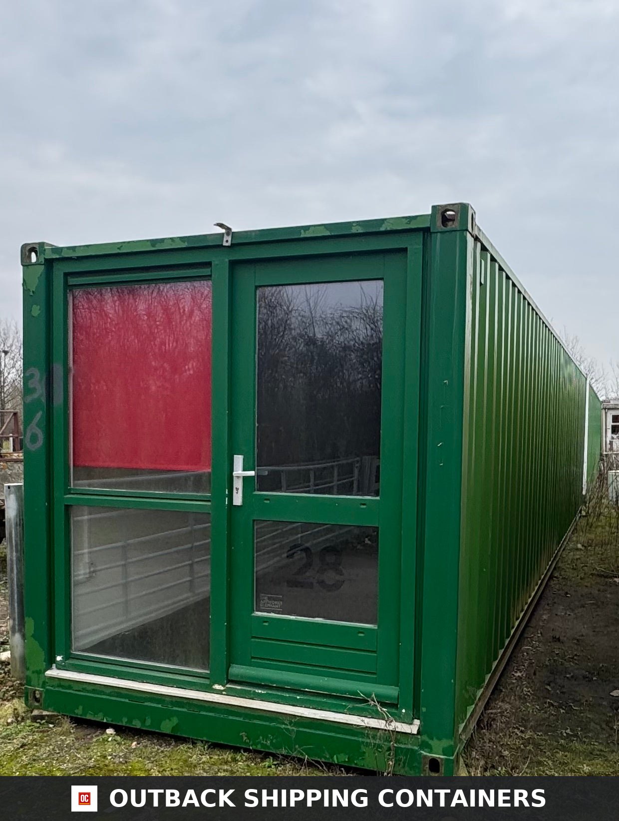 40 Ft Converted Shipping Container Home 40FT — Side Profile View | Outback Shipping Containers 40ft green converted shipping container home with two rooms featuring a glass entry door and large window frame