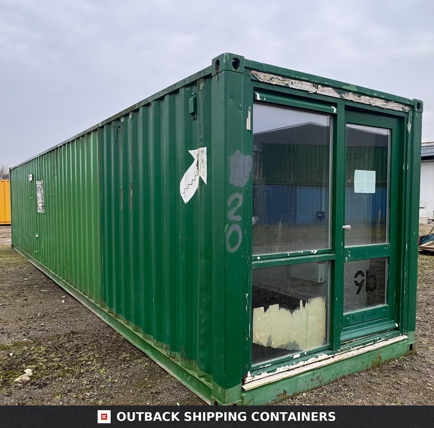 40 Ft Converted Shipping Container 40FT — Side Profile View | Outback Shipping Containers 40ft green shipping container office with large glass windows and door under an overcast sky