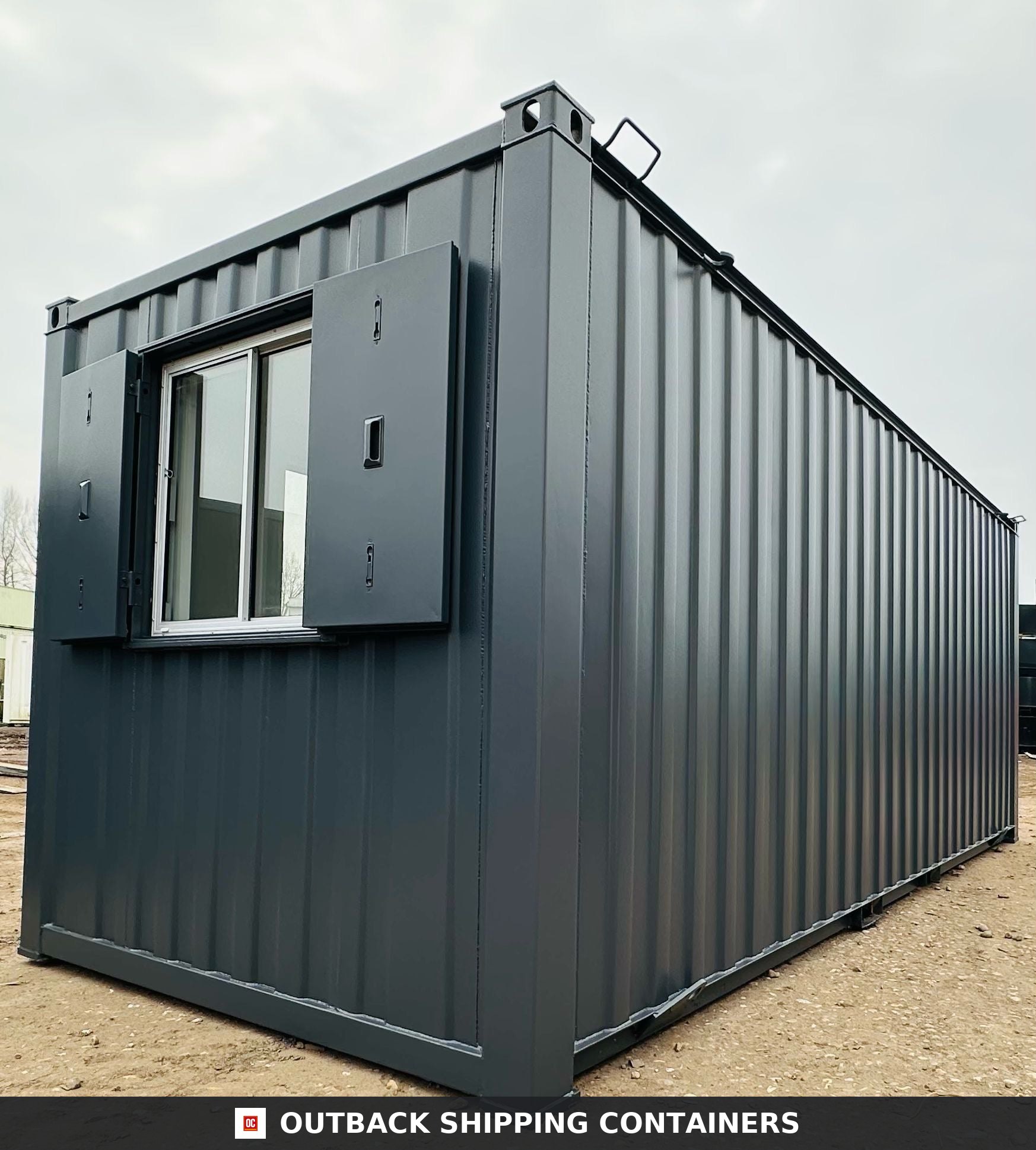 21x8ft for Sale — Interior View | Outback Shipping Containers 2 3 4 5 Refurbished 21ft gray shipping container office with a window and steel security shutters on a dirt lot