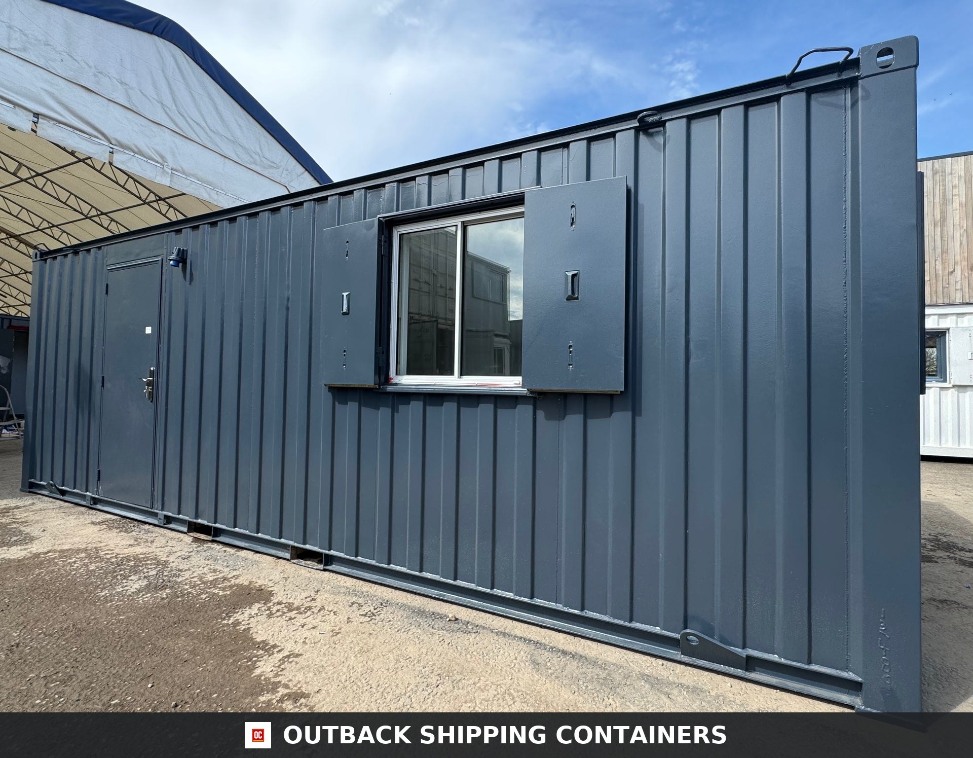 24x9 ft 24x9FT for Sale — Three-Quarter Angle View | Outback Shipping Containers Dark grey 24x9 ft anti-vandal shipping container office with a side door and window with steel security shutters