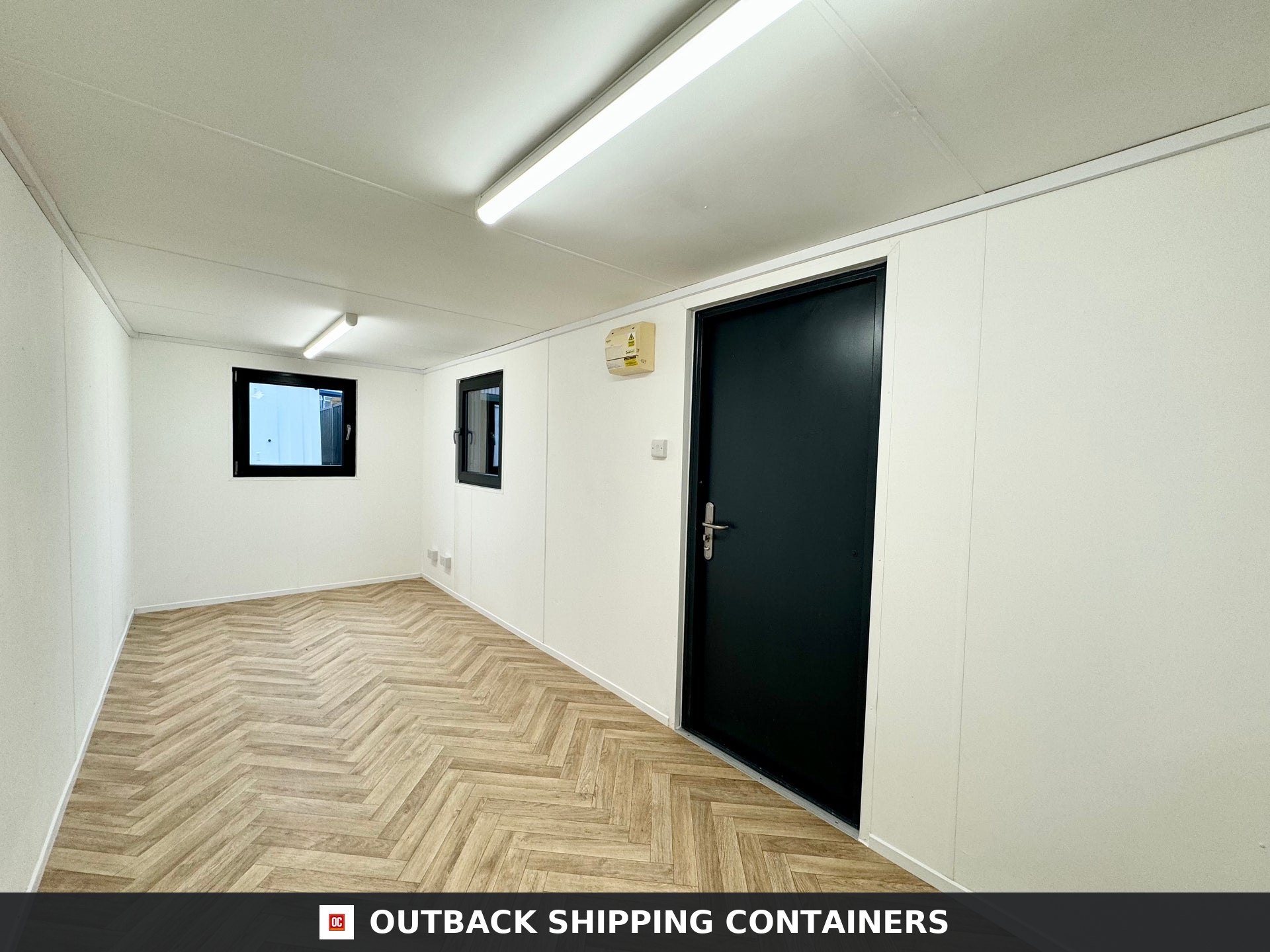 21x8ft Office Container for Sale — Interior Detail | Outback Shipping Containers 21x8ft refurbished office container with gray steel exterior, single personnel door, and shuttered window