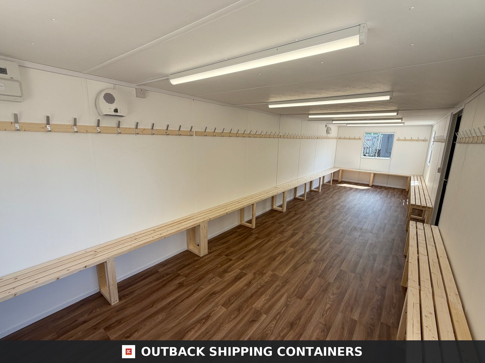 32x10ft Cabin for Sale — Corner Casting and Frame Detail | Outback Shipping Containers 2 3 4 Interior of a refurbished 32x10ft container cabin set up as a changing room with wooden benches and coat hooks