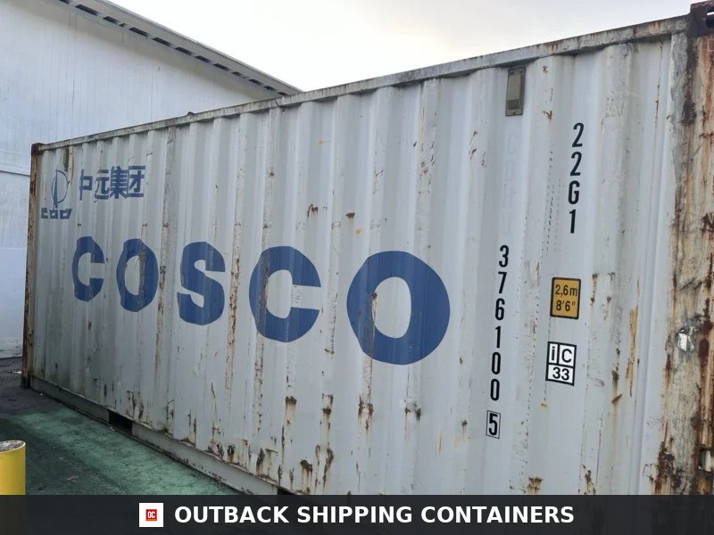 20ft Standard Storage Container — Three-Quarter Angle View | Outback Shipping Containers Side profile of a weathered white 20ft COSCO shipping container with vertical corrugated steel panels and blue lettering