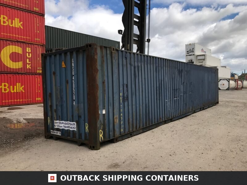 45ft used shipping container in blue steel showing some exterior surface rust and corrugated side panels in a cargo yard
