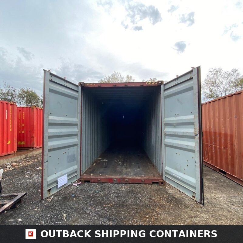 40ft shipping container with open double doors showing dark empty interior and wooden flooring