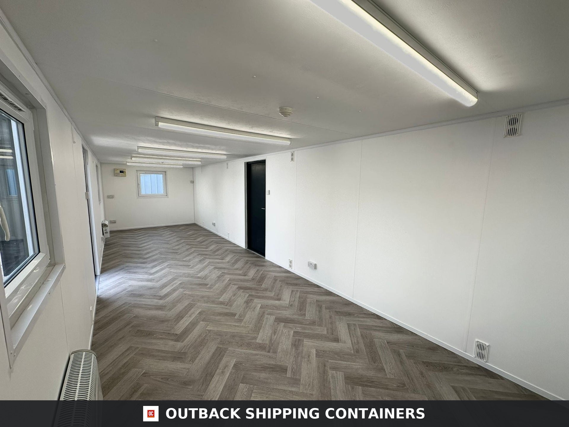 32x10ft Cabin for Sale — Rear Exterior View | Outback Shipping Containers 2 Interior view of a 32x10 refurbished portable office container with white walls and grey herringbone flooring