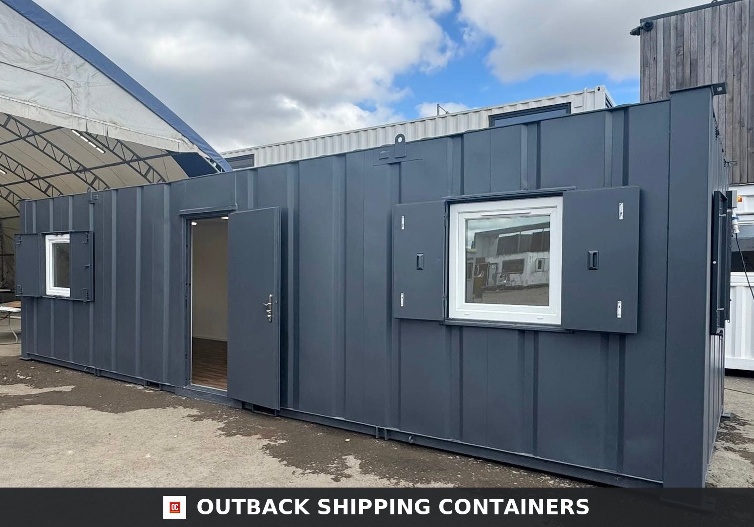 32ft Cabin for Sale — Door and Entry Detail | Outback Shipping Containers Refurbished 32ft anti-vandal portable cabin in dark grey with open door and windows showing white frames