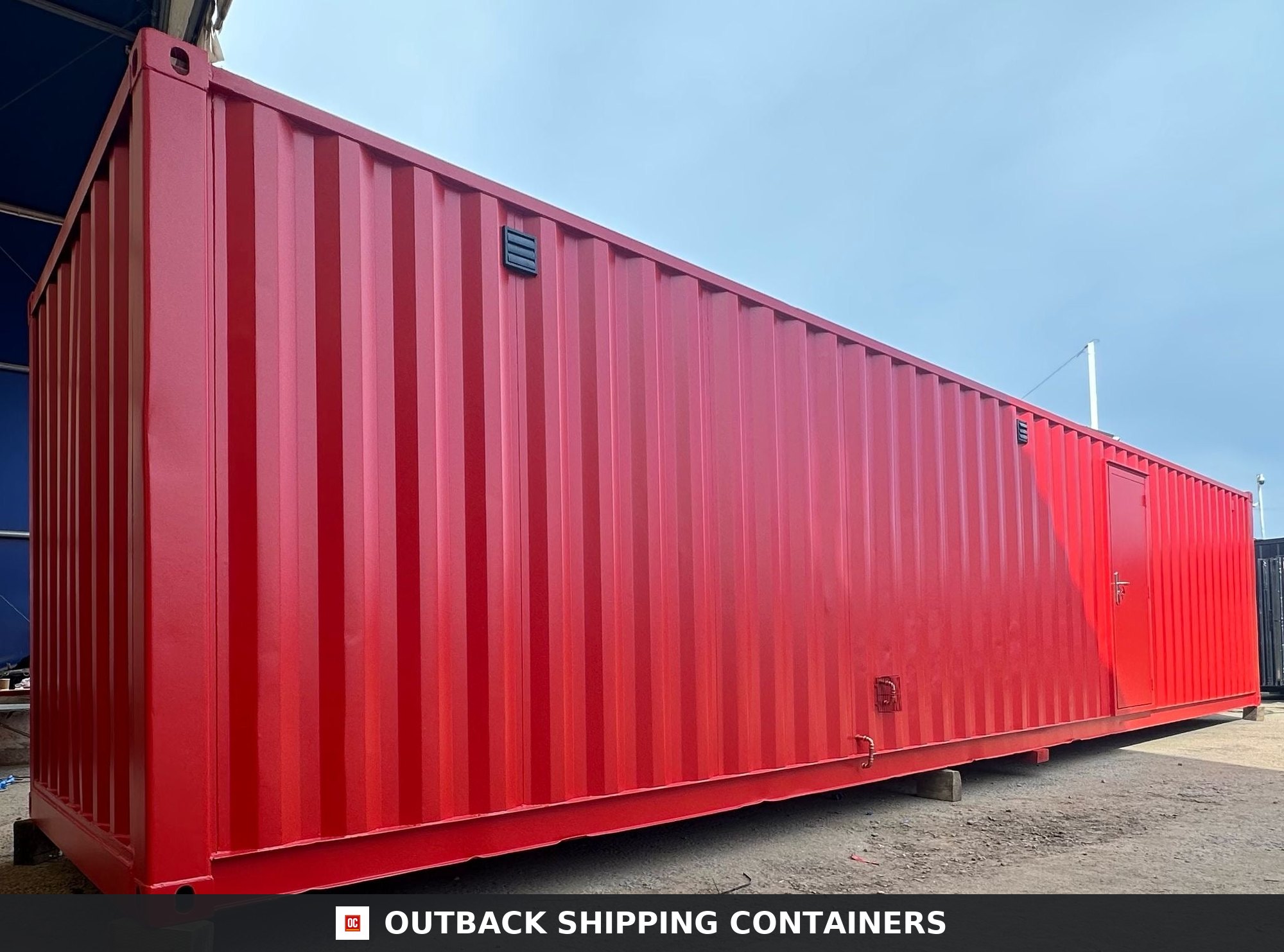 40x8ft for Sale — Door and Entry Detail | Outback Shipping Containers 2 Exterior side view of a refurbished 40ft red shipping container welfare unit with personnel door and ventilation grilles