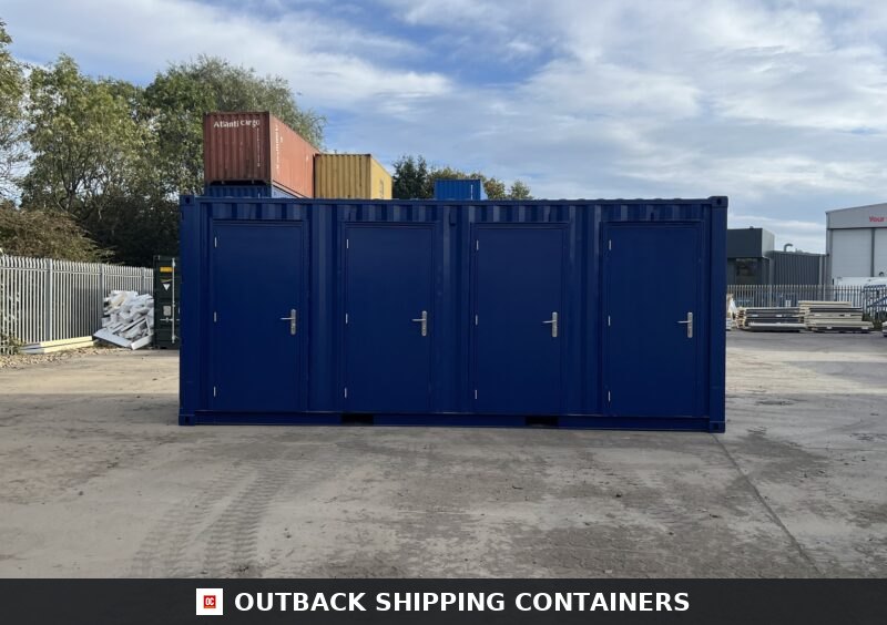 Blue 20ft shipping container storage unit with four side-access doors in an industrial outdoor lot