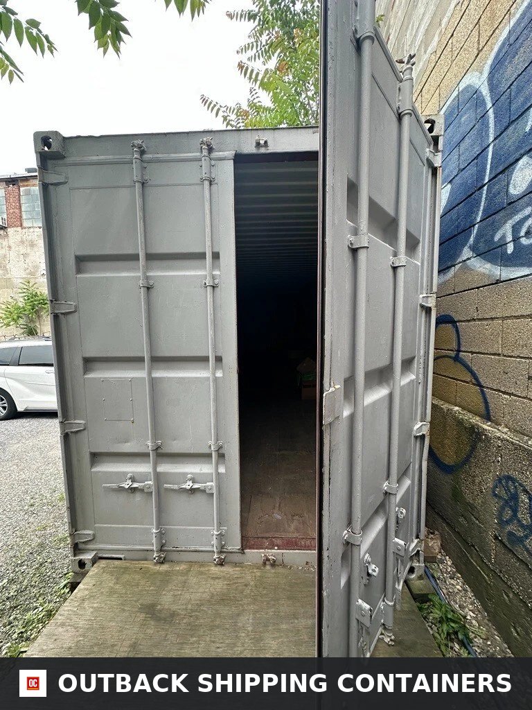 40ft high cube shipping container with one cargo door open showing the dark interior and wood flooring
