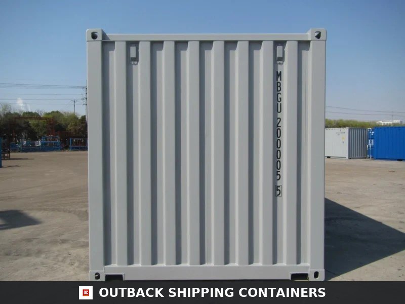20ft grey shipping container front panel view showing corrugated steel and corner castings on a flat concrete surface