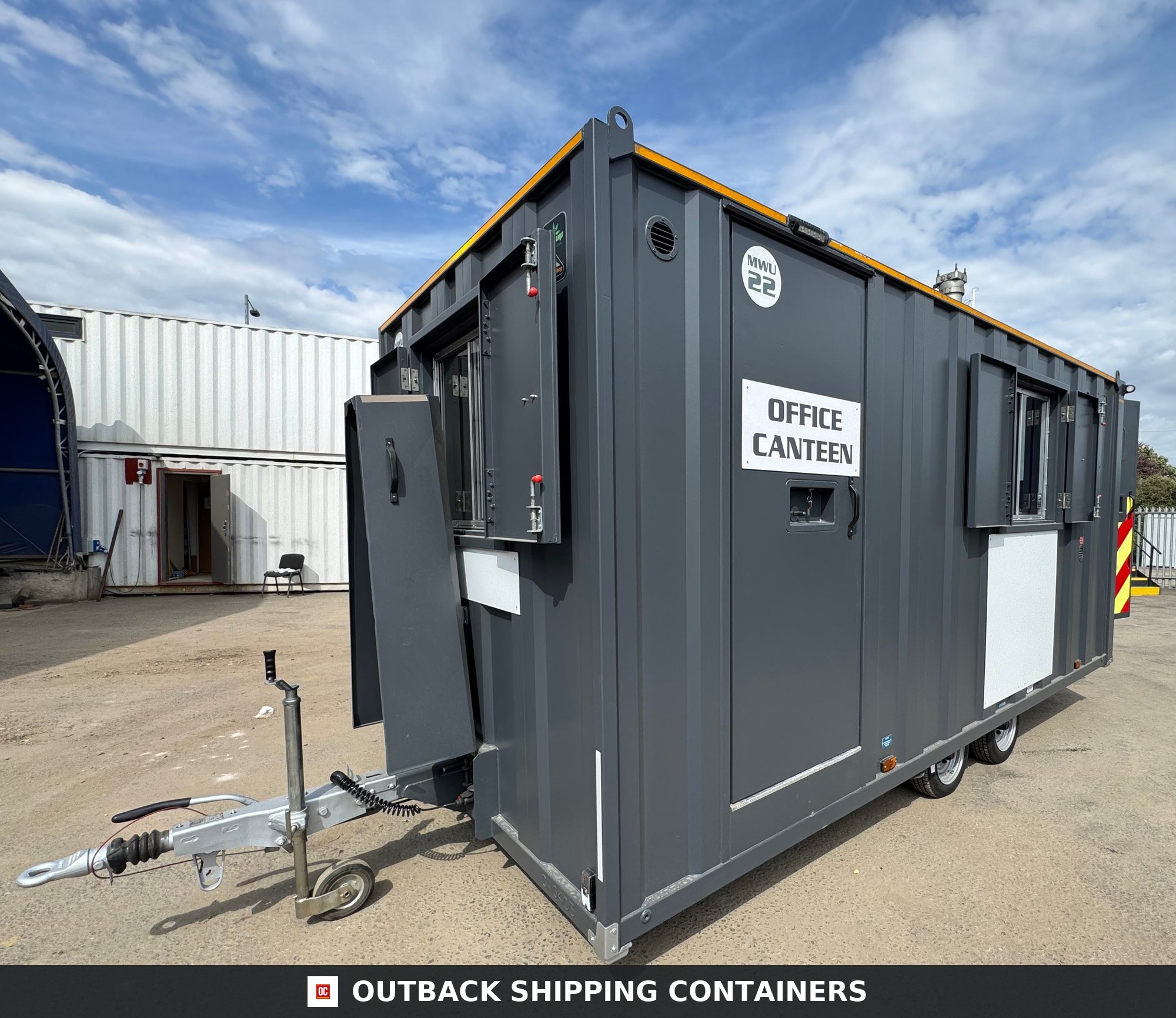 Groundhog Towable Mobile Welfare | 16 Ft | 2017 |Twin Axle — Window and Shutter Detail Side profile of a dark grey Groundhog towable mobile welfare unit with office canteen signage on a twin axle trailer