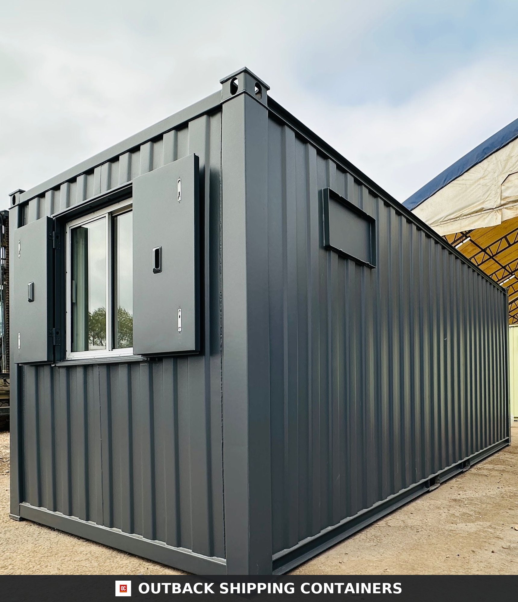 21x8ft for Sale — Roof and Structural Detail | Outback Shipping Containers Exterior view of a dark grey 21x8ft anti-vandal portable office unit with steel shutters and secure door