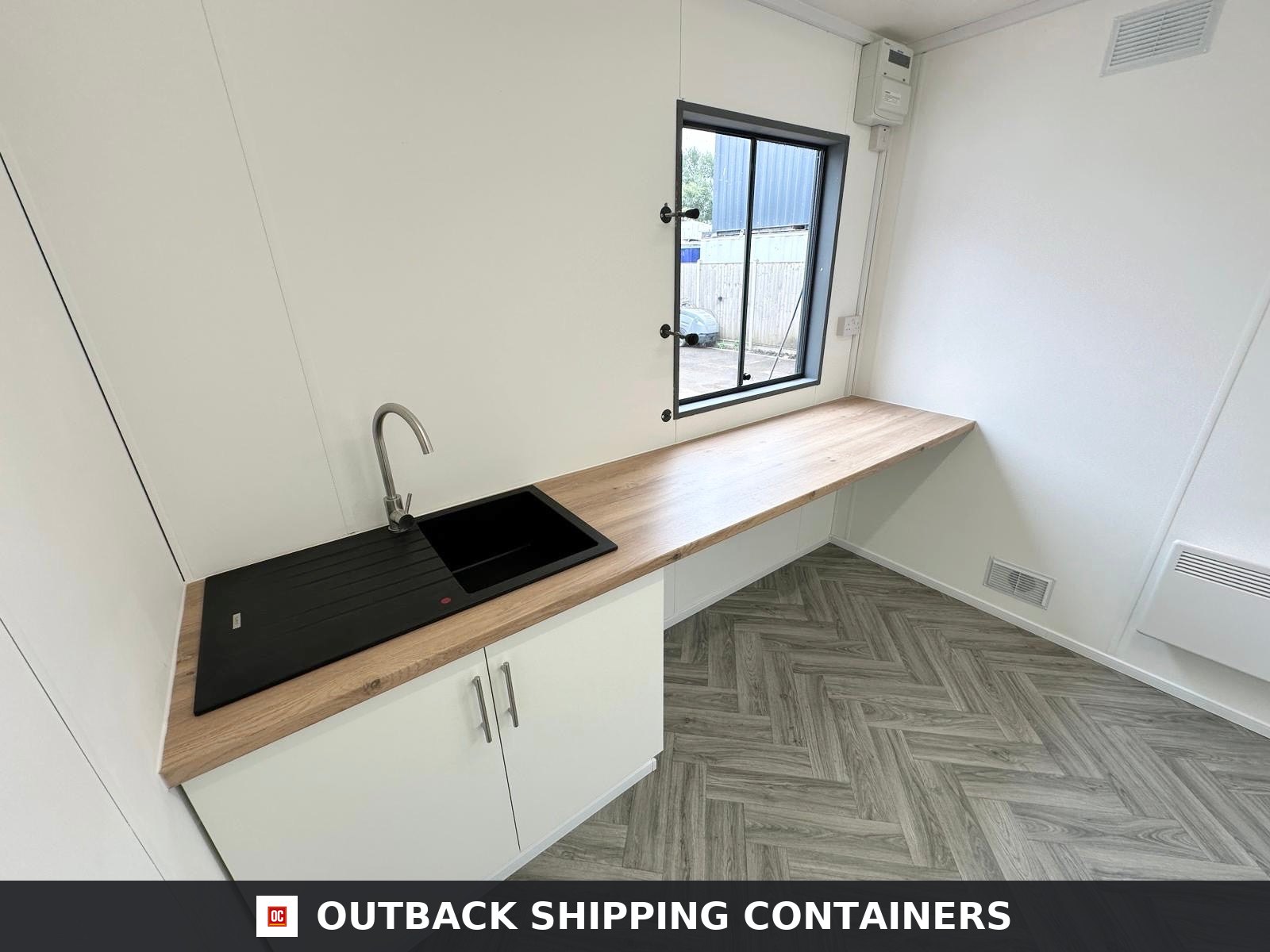 32x10Ft for Sale — Side Profile View | Outback Shipping Containers Refurbished grey 32x10 canteen office cabin with entry door and shuttered windows on a gravel surface