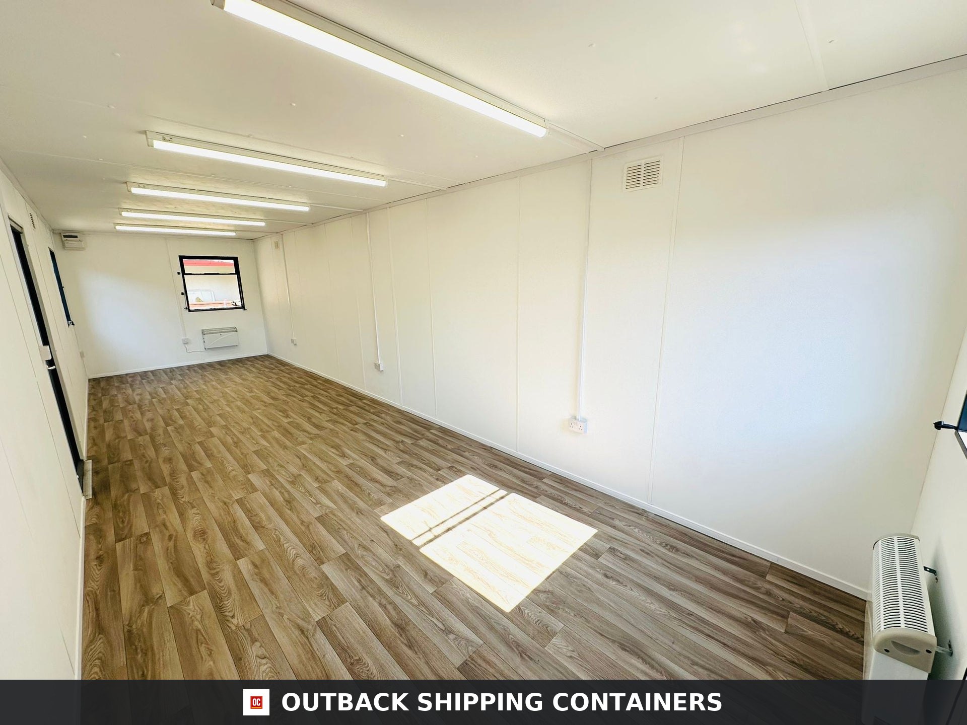 32x10ft Cabin for Sale — Corner Casting and Frame Detail | Outback Shipping Containers 2 3 Interior view of a 32x10 refurbished open plan portable office cabin with vinyl wood flooring and LED lighting